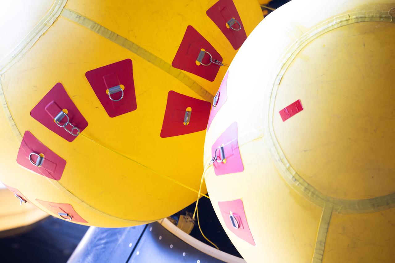 Airbags as part of the Orion crew module uprighting system are seen on the Crew Module Test Article (CMTA) as teams prepare to practice Artemis recovery operations during Underway Recovery Test-12 onboard USS Somerset, Thursday, March 27, 2025. During the test, NASA and Department of Defense teams are practicing to ensure recovery procedures are validated as NASA plans to send the Artemis II astronauts around the Moon and splashdown in the Pacific Ocean.  Photo Credit: (NASA/Joel Kowsky)