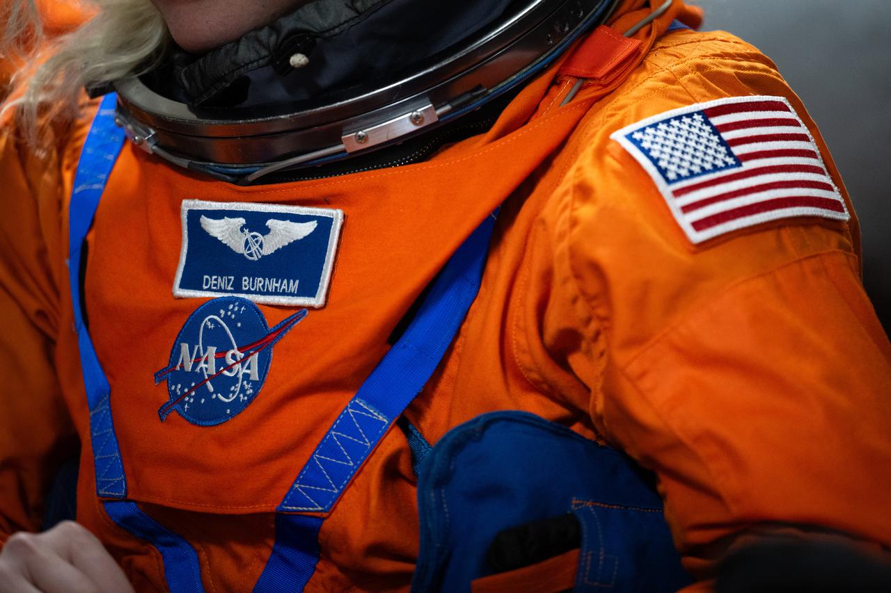 NASA astronaut Deniz Burnham is seen as she prepares to take part in practicing Artemis recovery operations during Underway Recovery Test-12 onboard USS Somerset, Thursday, March 27, 2025. During the test, NASA and Department of Defense teams are practicing to ensure recovery procedures are validated as NASA plans to send the Artemis II astronauts around the Moon and splashdown in the Pacific Ocean.  Photo Credit: (NASA/Joel Kowsky)