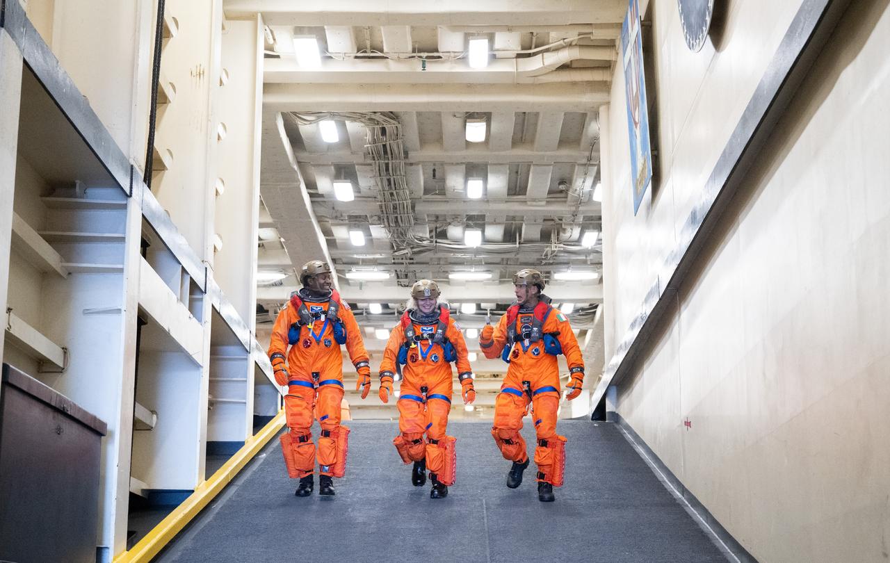 NASA astronauts Andre Douglas, Deniz Burnham, and ESA (European Space Agency) astronaut Luca Parmitano are seen onboard the USS Somerset as they prepare to practice recovery procedures during Underway Recovery Test-12, Thursday, March 27, 2025. During the test, NASA and Department of Defense teams are practicing to ensure recovery procedures are validated as NASA plans to send the Artemis II astronauts around the Moon and splashdown in the Pacific Ocean.  Photo Credit: (NASA/Joel Kowsky)