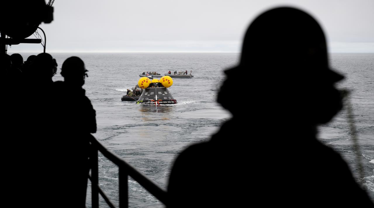 Teams work to recover the Crew Module Test Article (CMTA), a full scale replica of the Orion spacecraft, as they practice Artemis recovery operations during Underway Recovery Test-12 onboard USS Somerset off the coast of California, Thursday, March 27, 2025. During the test, NASA and Department of Defense teams are practicing to ensure recovery procedures are validated as NASA plans to send the Artemis II astronauts around the Moon and splashdown in the Pacific Ocean.  Photo Credit: (NASA/Joel Kowsky)