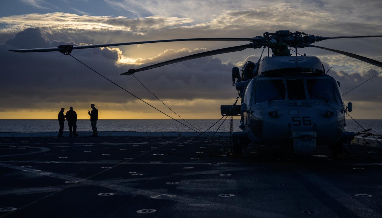 Navy MH-60 Seahawk helicopter team members are seen onboard USS Somerset off the coast of California, as NASA and Department of Defense teams participate in Underway Recovery Test-12, Friday, March 28, 2025. During the test, teams are practicing to ensure recovery procedures are validated as NASA plans to send the Artemis II astronauts around the Moon and splashdown in the Pacific Ocean.  Photo Credit: (NASA/Bill Ingalls)