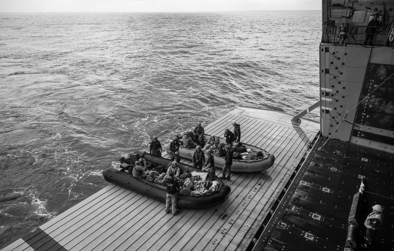 ESA (European Space Agency) astronaut Luca Parmitano, and NASA astronauts Andre Douglas, Deniz Burnham, and Stan Love, right, board boats to deliver them to the Crew Module Test Article (CMTA), a full scale mockup of the Orion spacecraft, during Underway Recovery Test-12 off the coast of California, Friday, March 28, 2025. During the test, NASA and Department of Defense teams are practicing to ensure recovery procedures are validated as NASA plans to send Artemis II astronauts around the Moon and splashdown in the Pacific Ocean.  Photo Credit: (NASA/Bill Ingalls)