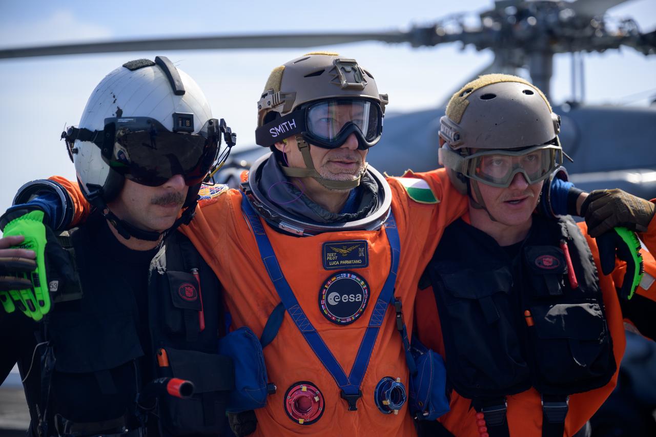 ESA (European Space Agency) astronaut Luca Parmitano is helped from a Navy helicopter after returning to USS Somerset from the Crew Module Test Article (CMTA), a full scale mockup of the Orion spacecraft, during Underway Recovery Test-12 off the coast of California, Friday, March 28, 2025. During the test, NASA and Department of Defense teams are practicing to ensure recovery procedures are validated as NASA plans to send Artemis II astronauts around the Moon and splashdown in the Pacific Ocean. Photo Credit: (NASA/Bill Ingalls)