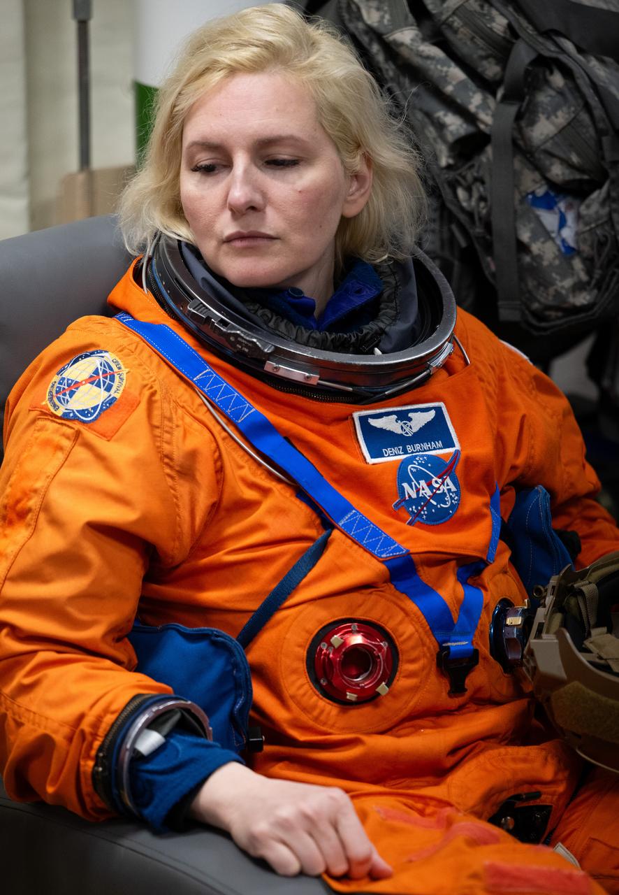 NASA astronaut Deniz Burnham is seen as she prepares to take part in practicing Artemis recovery procedures during Underway Recovery Test-12 onboard USS Somerset off the coast of California, Friday, March 28, 2025. During the test, NASA and Department of Defense teams are practicing to ensure recovery procedures are validated as NASA plans to send the Artemis II astronauts around the Moon and splashdown in the Pacific Ocean.  Photo Credit: (NASA/Joel Kowsky)
