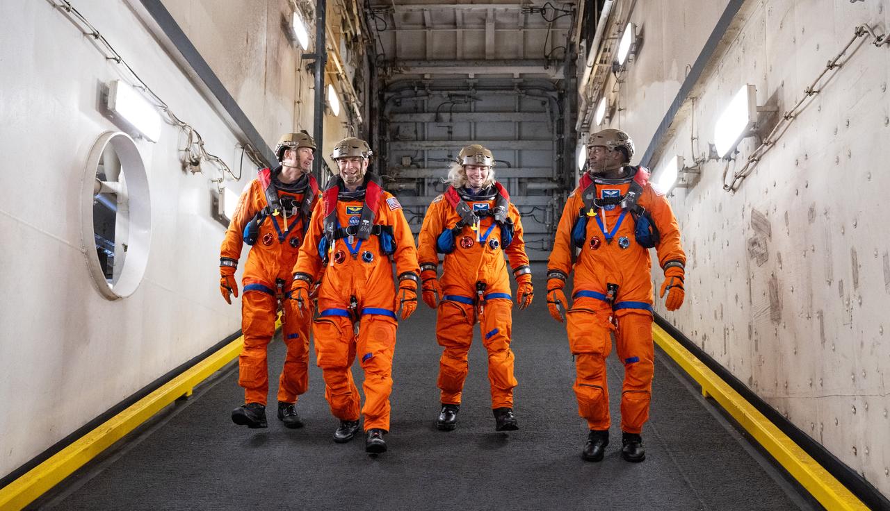 ESA (European Space Agency) astronaut Luca Parmitano, left, and NASA astronauts Stan Love, Deniz Burnham, and Andre Douglas are seen as they prepare to take part in practicing Artemis recovery operations during Underway Recovery Test-12 onboard USS Somerset off the coast of California, Friday, March 28, 2025. During the test, NASA and Department of Defense teams are practicing to ensure recovery procedures are validated as NASA plans to send the Artemis II astronauts around the Moon and splashdown in the Pacific Ocean.  Photo Credit: (NASA/Joel Kowsky)