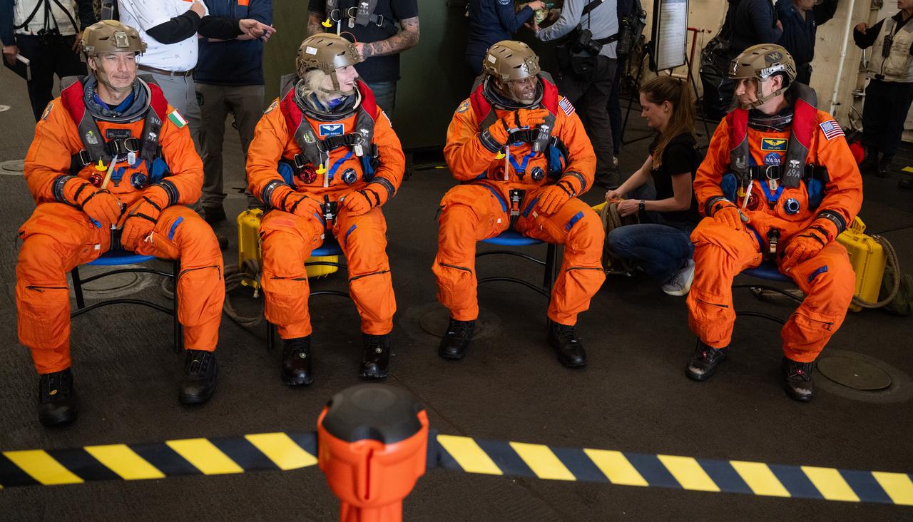 ESA (European Space Agency) astronaut Luca Parmitano, left, and NASA astronauts Deniz Burnham, Andre Douglas, and Stan Love are seen outside the operational clear zone as they prepare to take part in practicing Artemis recovery operations during Underway Recovery Test-12 onboard USS Somerset off the coast of California, Friday, March 28, 2025. During the test, NASA and Department of Defense teams are practicing to ensure recovery procedures are validated as NASA plans to send the Artemis II astronauts around the Moon and splashdown in the Pacific Ocean.  Photo Credit: (NASA/Joel Kowsky)