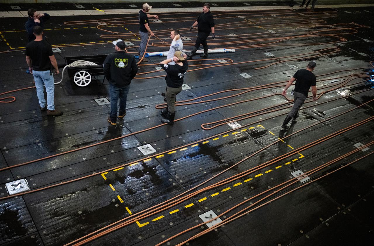 Members of NASA’s Landing and Recovery team clean up after completing the days activities during Underway Recovery Test-12 onboard USS Somerset off the coast of California, Saturday, March 29, 2025. During the test, NASA and Department of Defense teams are practicing to ensure recovery procedures are validated as NASA plans to send the Artemis II astronauts around the Moon and splashdown in the Pacific Ocean.  Photo Credit: (NASA/Joel Kowsky)