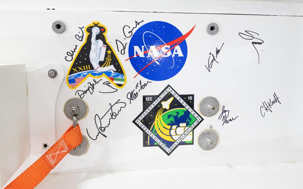 Signatures of astronauts who have participated in Artemis recovery training are seen on a panel inside the Crew Module Test Article (CMTA) during Underway Recovery Test-12 onboard USS Somerset off the coast of California, Saturday, March 29, 2025. During the test, NASA and Department of Defense teams are practicing to ensure recovery procedures are validated as NASA plans to send the Artemis II astronauts around the Moon and splashdown in the Pacific Ocean.  Photo Credit: (NASA/Joel Kowsky)