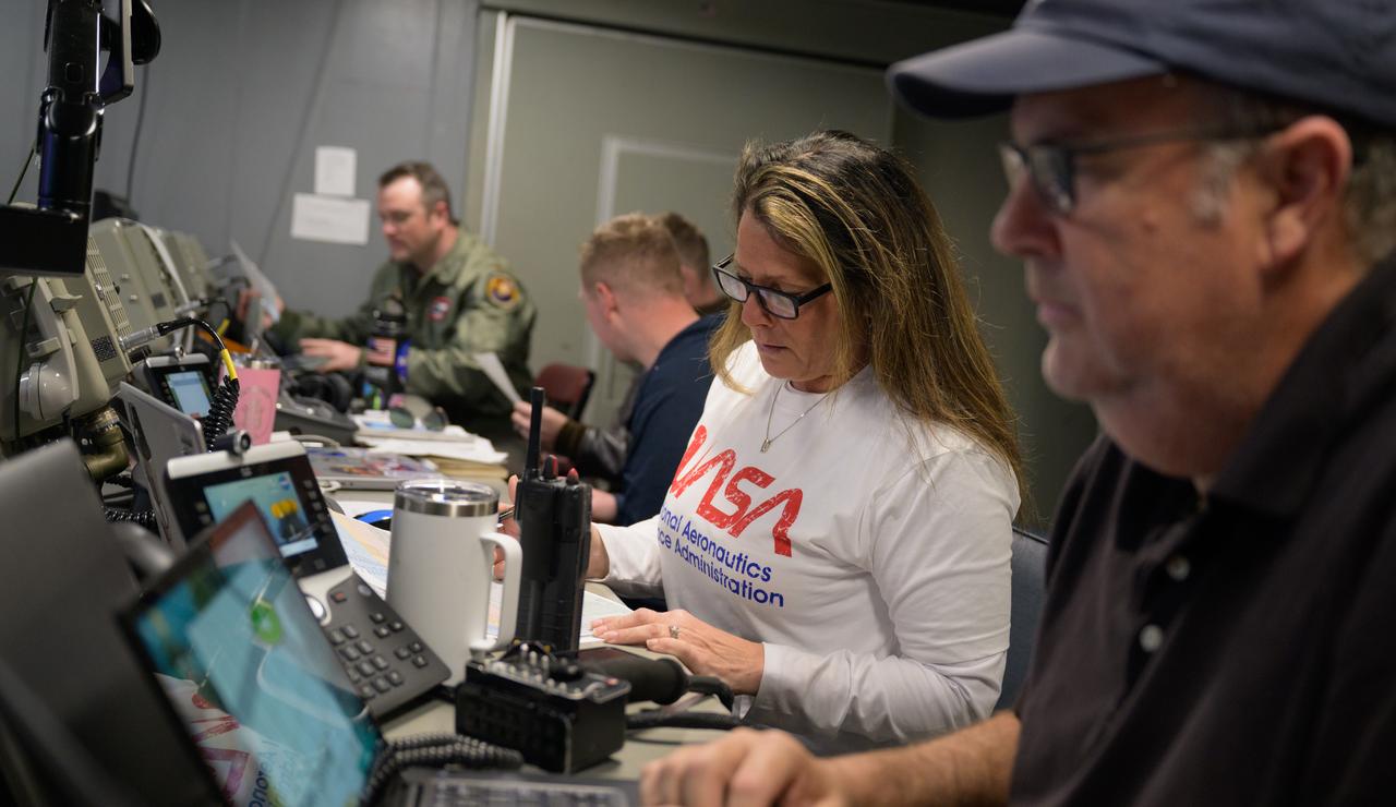 Lisa Seiler, Artemis Landing and Recovery deputy director, works inside the Landing Force Operations Center onboard USS Somerset as they practice Artemis recovery operations during Underway Recovery Test-12 off the coast of California, Saturday, March 29, 2025. During the test, NASA and Department of Defense teams are practicing to ensure recovery procedures are validated as NASA plans to send Artemis II around the Moon and splashdown in the Pacific Ocean.  Photo Credit: (NASA/Bill Ingalls)