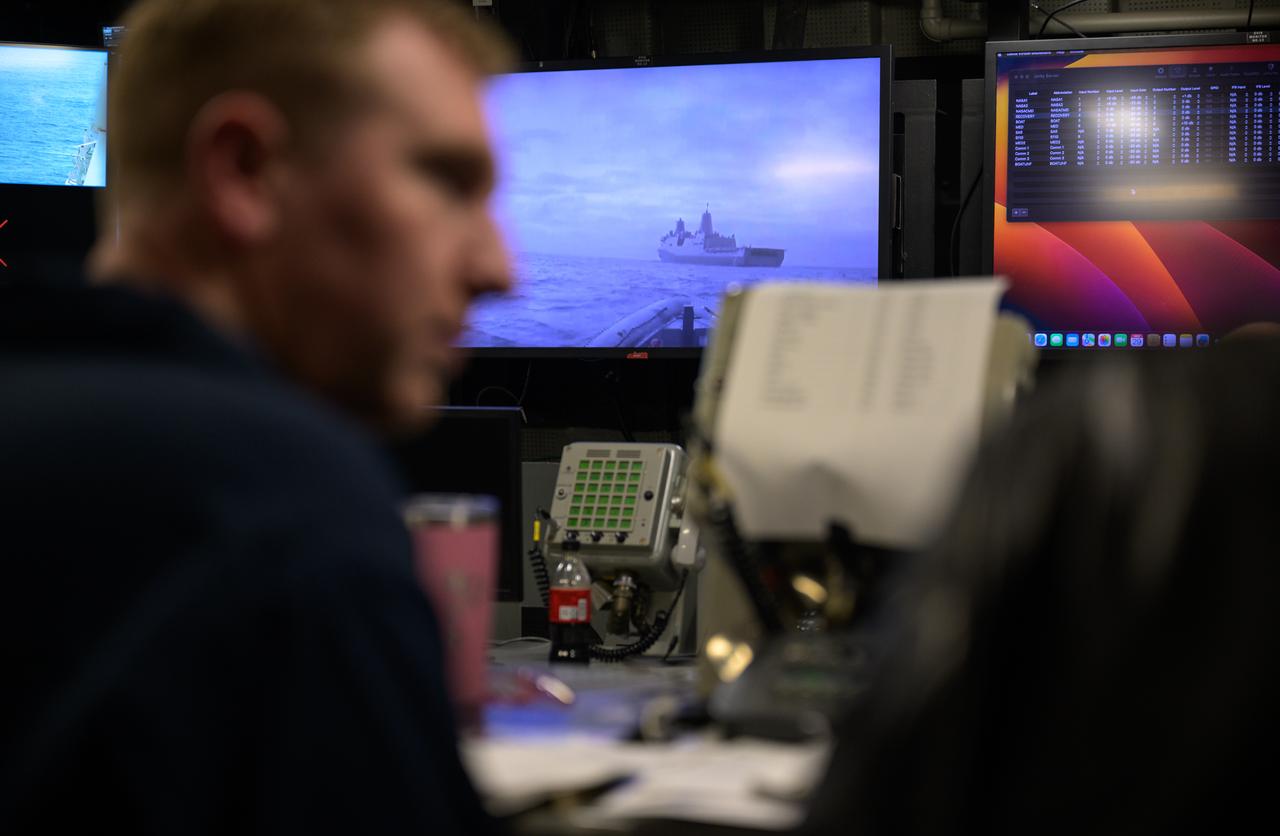 Members of the NASA and Department of Defense recovery team work inside the Landing Force Operations Center onboard USS Somerset as they practice Artemis recovery operations during Underway Recovery Test-12 off the coast of California, Saturday, March 29, 2025. During the test, NASA and Department of Defense teams are practicing to ensure recovery procedures are validated as NASA plans to send Artemis II around the Moon and splashdown in the Pacific Ocean.  Photo Credit: (NASA/Bill Ingalls)