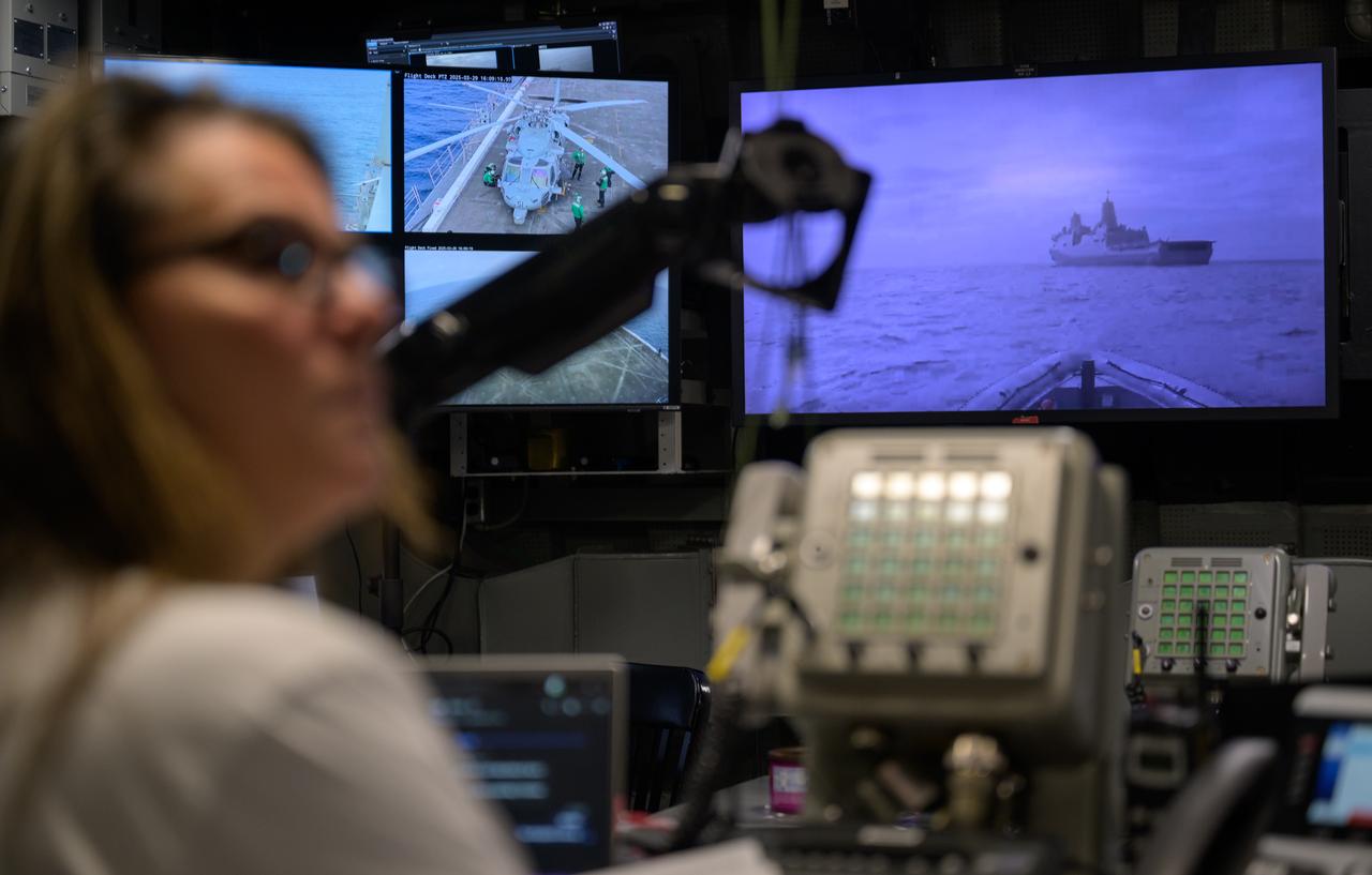 Lisa Seiler, Artemis Landing and Recovery deputy director, works inside the Landing Force Operations Center onboard USS Somerset as they practice Artemis recovery operations during Underway Recovery Test-12 off the coast of California, Saturday, March 29, 2025. During the test, NASA and Department of Defense teams are practicing to ensure recovery procedures are validated as NASA plans to send Artemis II around the Moon and splashdown in the Pacific Ocean.  Photo Credit: (NASA/Bill Ingalls)