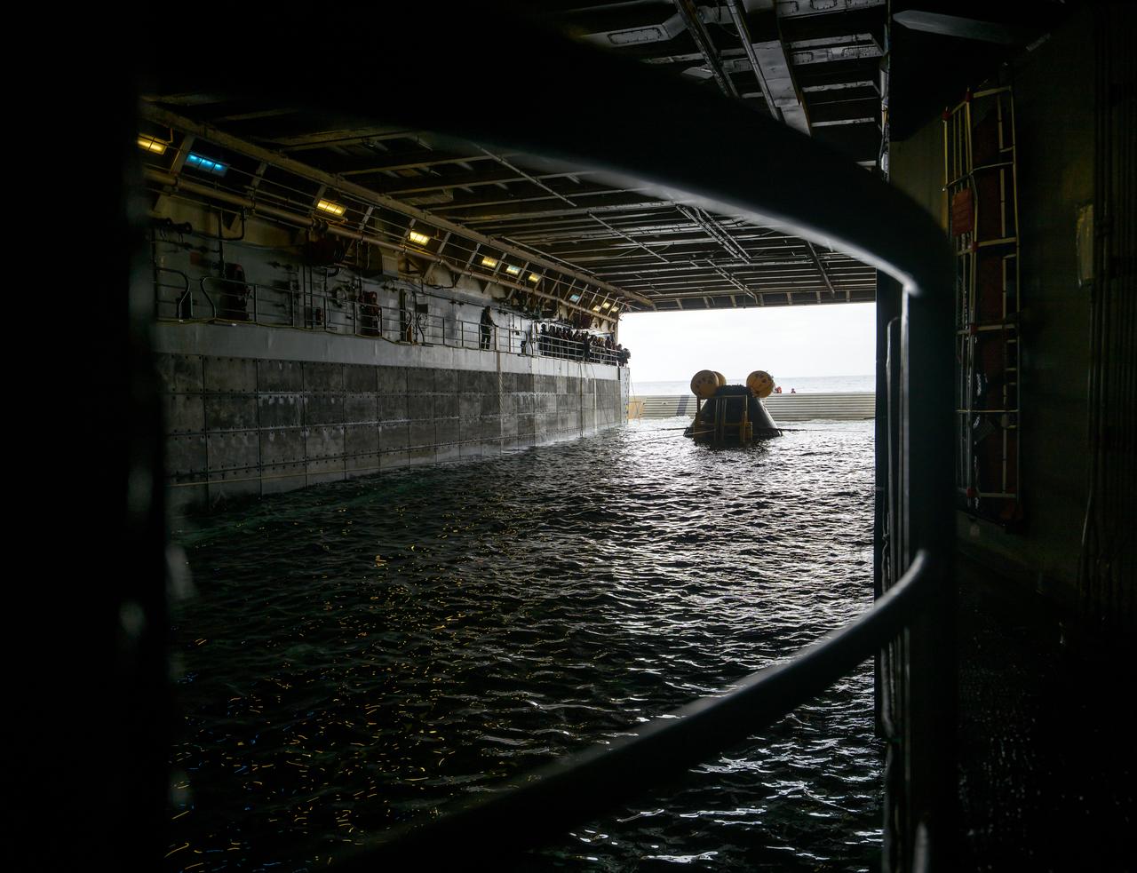 The Crew Module Test Article (CMTA), a full scale mockup of the Orion spacecraft, sits nestled in its cradle during Underway Recovery Test-12 onboard USS Somerset off the coast of California, Saturday, March 29, 2025. During the test, NASA and Department of Defense teams are practicing to ensure recovery procedures are validated as NASA plans to send Artemis II around the Moon and splashdown in the Pacific Ocean. Photo Credit: (NASA/Bill Ingalls)