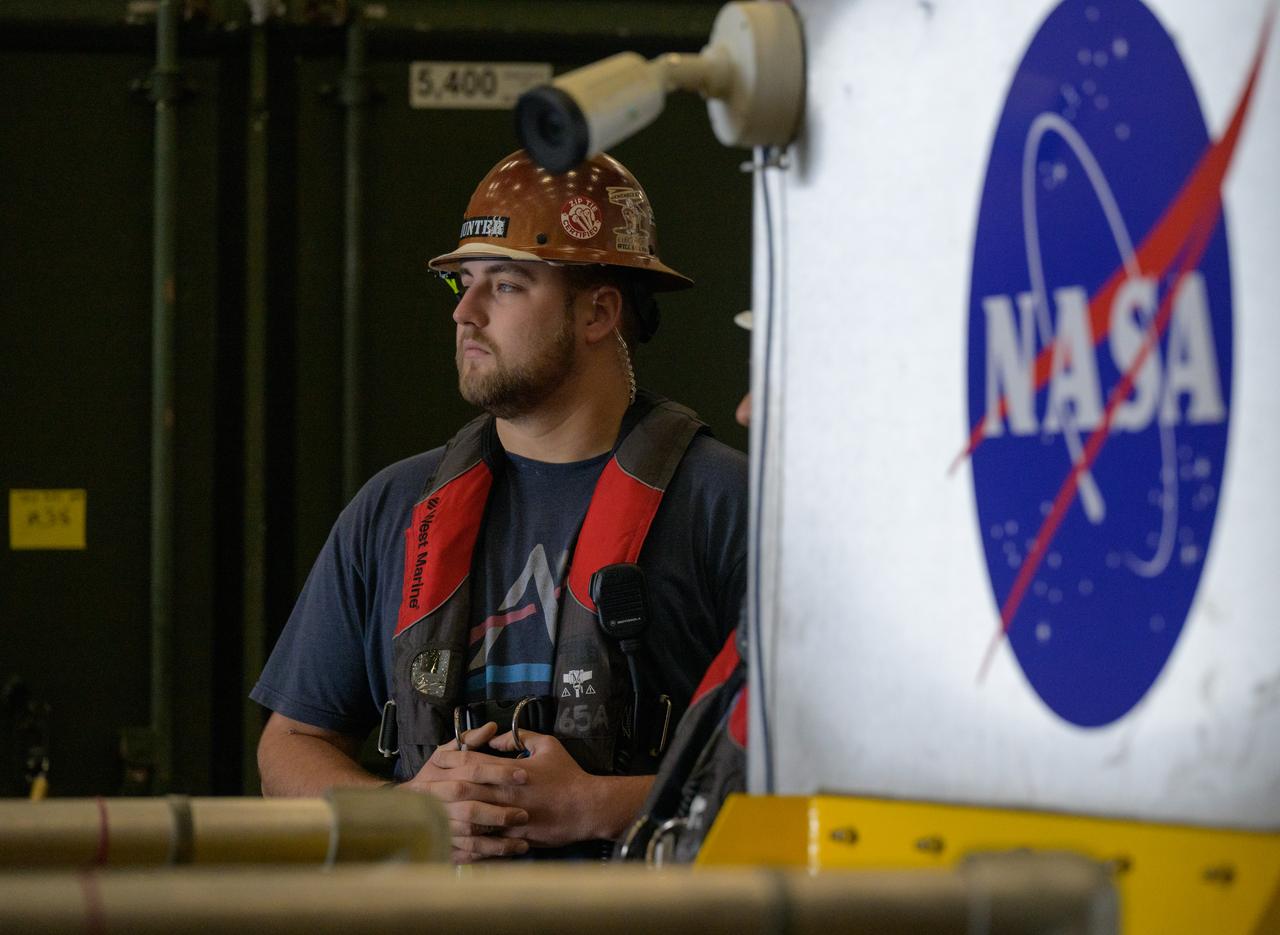 Members of NASA’s Landing and Recovery team are seen as they recover the Crew Module Test Article (CMTA), a full scale mockup of the Orion spacecraft, as teams  practice Artemis recovery operations during Underway Recovery Test-12 onboard USS Somerset off the coast of California, Saturday, March 29, 2025. During the test, NASA and Department of Defense teams are practicing to ensure recovery procedures are validated as NASA plans to send Artemis II around the Moon and splashdown in the Pacific Ocean.  Photo Credit: (NASA/Bill Ingalls)