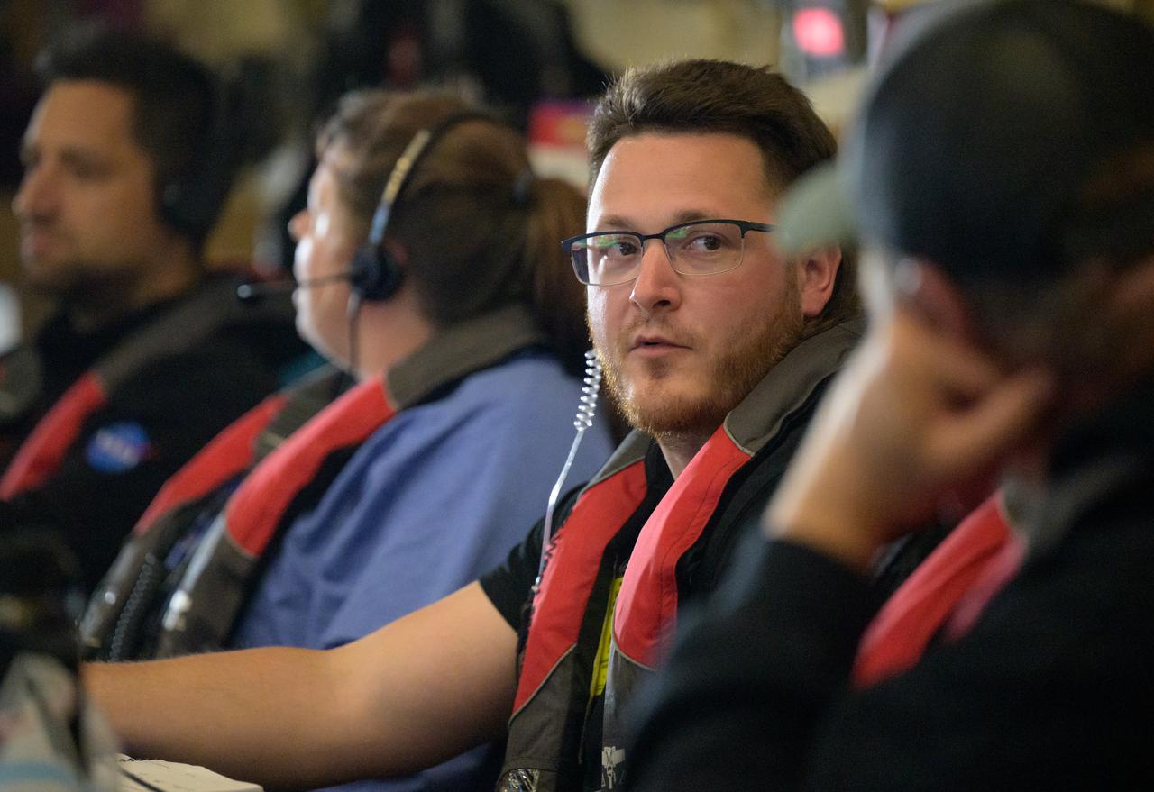 Members of NASA’s Landing and Recovery team are seen as they recover the Crew Module Test Article (CMTA), a full scale mockup of the Orion spacecraft, as teams  practice Artemis recovery operations during Underway Recovery Test-12 onboard USS Somerset off the coast of California, Saturday, March 29, 2025. During the test, NASA and Department of Defense teams are practicing to ensure recovery procedures are validated as NASA plans to send Artemis II around the Moon and splashdown in the Pacific Ocean.  Photo Credit: (NASA/Bill Ingalls)