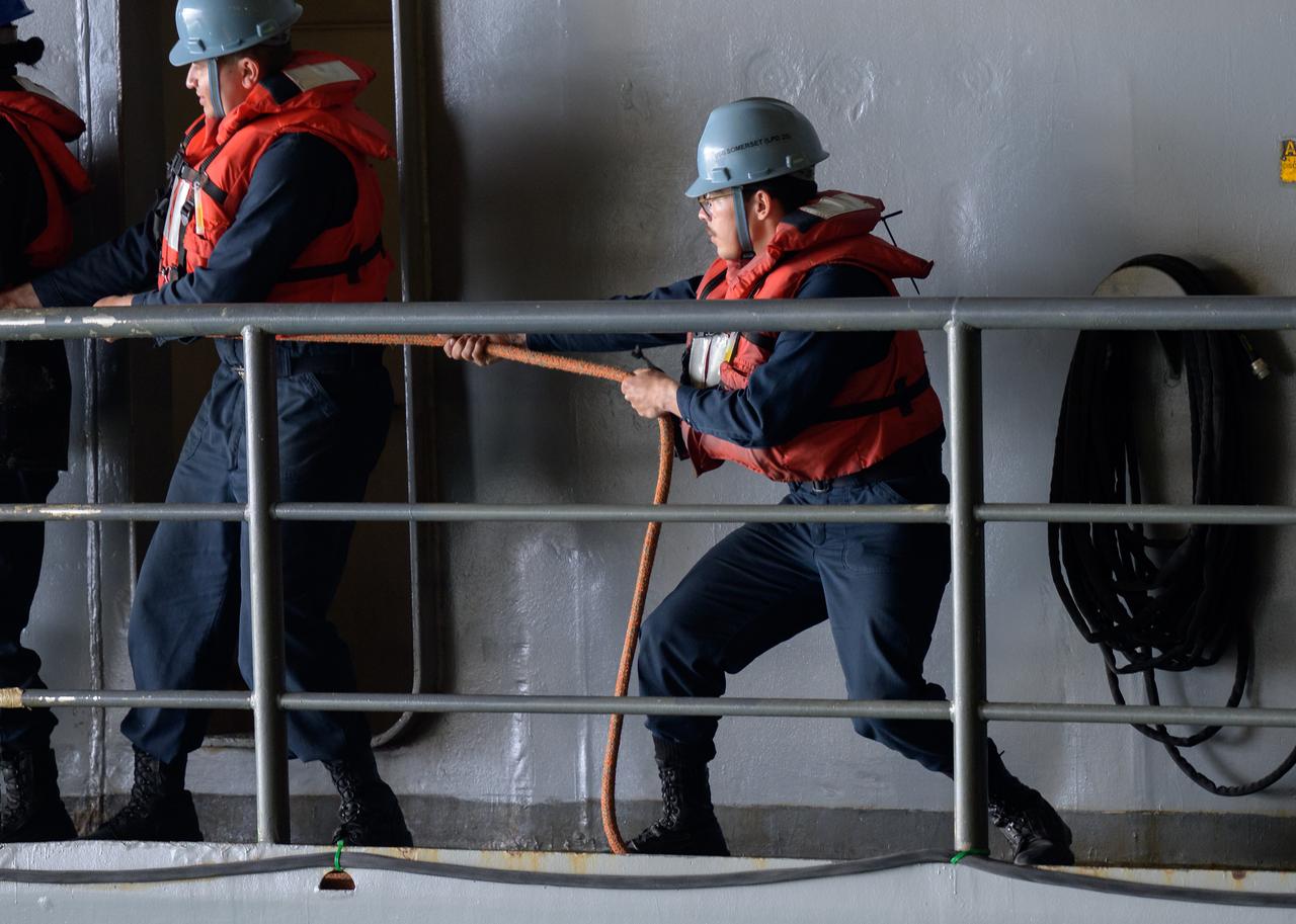 Sailors from USS Somerset assist in the recovery of the Crew Module Test Article (CMTA), a full scale mockup of the Orion spacecraft, as teams practice Artemis recovery operations during Underway Recovery Test-12 onboard USS Somerset off the coast of California, Saturday, March 29, 2025. During the test, NASA and Department of Defense teams are practicing to ensure recovery procedures are validated as NASA plans to send Artemis II around the Moon and splashdown in the Pacific Ocean.  Photo Credit: (NASA/Bill Ingalls)
