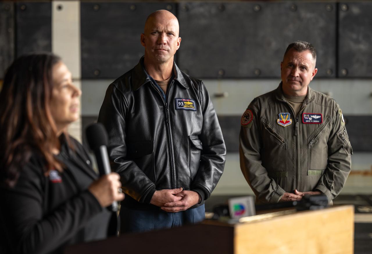 Liliana Villarreal, NASA’s Artemis II landing and recovery director, Exploration Ground Systems Program, gives remarks, as Capt. Andrew “Andy” Koy, commanding officer of USS Somerset (LPD 25), U.S. Navy, left, and Lt. Col. David Mahan, commander, U.S. Air Force’s 1st Air Force, Detachment 3, Patrick Space Force Base, Florida, look on,  during a media event where NASA and the Department of Defense discussed the recovery operations that will bring the Artemis II astronauts and the agency’s Orion spacecraft home at the conclusion of next year’s mission around the Moon, Monday, March 31, 2025, onboard USS Somerset at Naval Base San Diego, in California. The teams spent the week practicing the procedures they will use to recover the astronauts after their more than 600,000 mile journey from Earth to the Moon and back on the first crewed mission under the Artemis campaign. Photo Credit: (NASA/Bill Ingalls)