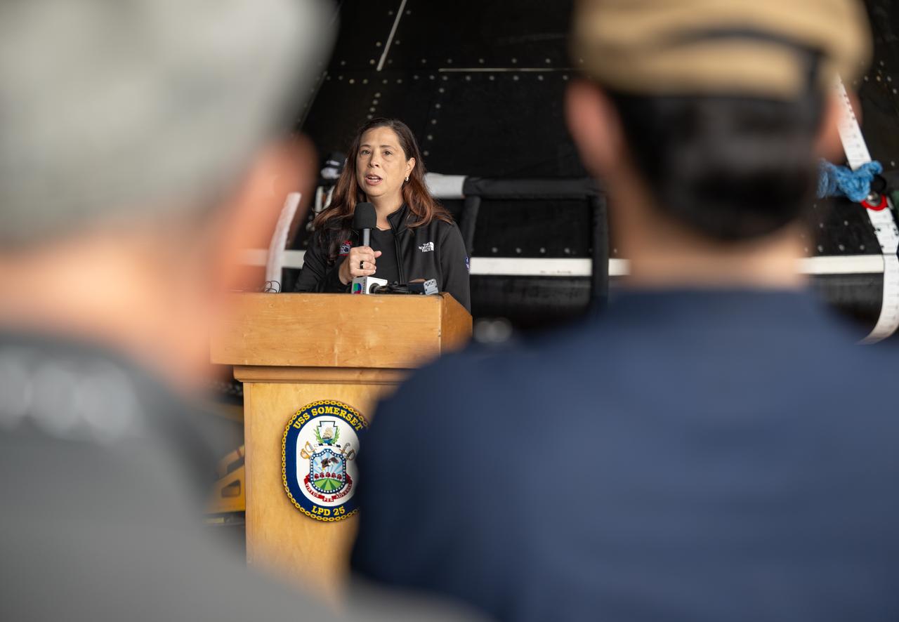 Liliana Villarreal, NASA’s Artemis II landing and recovery director, Exploration Ground Systems Program, gives remarks during a media event where NASA and the Department of Defense discussed the recovery operations that will bring the Artemis II astronauts and the agency’s Orion spacecraft home at the conclusion of next year’s mission around the Moon, Monday, March 31, 2025, onboard USS Somerset at Naval Base San Diego, in California. The teams spent the week practicing the procedures they will use to recover the astronauts after their more than 600,000 mile journey from Earth to the Moon and back on the first crewed mission under the Artemis campaign. Photo Credit: (NASA/Bill Ingalls)