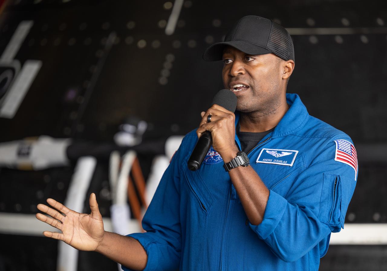 NASA astronaut Andre Douglas gives remarks during a media event where NASA and the Department of Defense discussed the recovery operations that will bring the Artemis II astronauts and the agency’s Orion spacecraft home at the conclusion of next year’s mission around the Moon, Monday, March 31, 2025, onboard USS Somerset at Naval Base San Diego, in California. The teams spent the week practicing the procedures they will use to recover the astronauts after their more than 600,000 mile journey from Earth to the Moon and back on the first crewed mission under the Artemis campaign. Photo Credit: (NASA/Bill Ingalls)