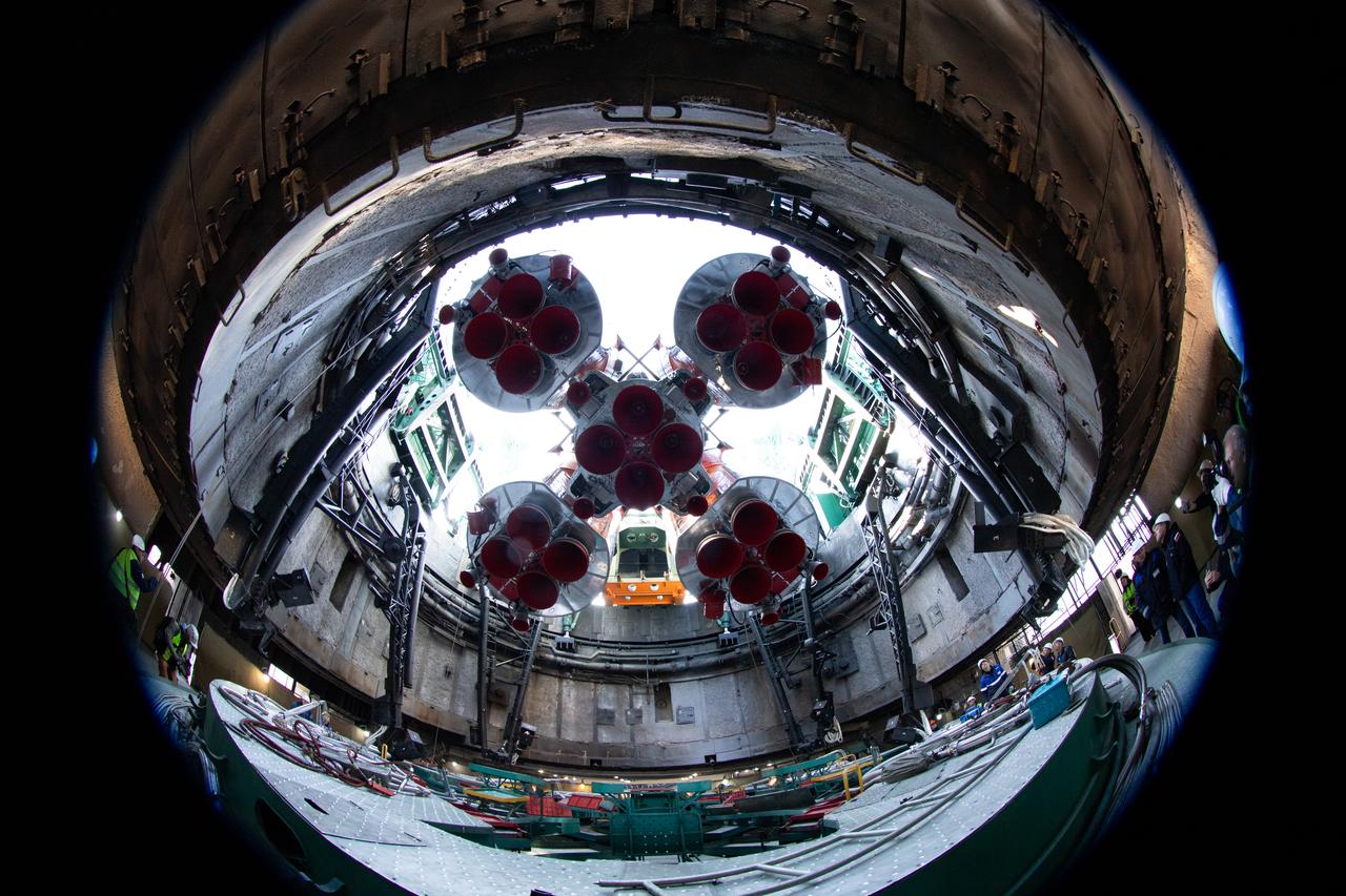 In this image taken with a circular fisheye lens, the Soyuz rocket is seen as it is raised into a vertical position after being rolled out by train to the launch pad at Site 31, Saturday, April 5, 2025, at the Baikonur Cosmodrome in Kazakhstan. Expedition 73 crewmembers: NASA astronaut Jonny Kim, and Roscosmos cosmonauts Sergey Ryzhikov and Alexey Zubritskiy, are scheduled to launch aboard their Soyuz MS-27 spacecraft on April 8. Photo Credit: (NASA/Joel Kowsky)