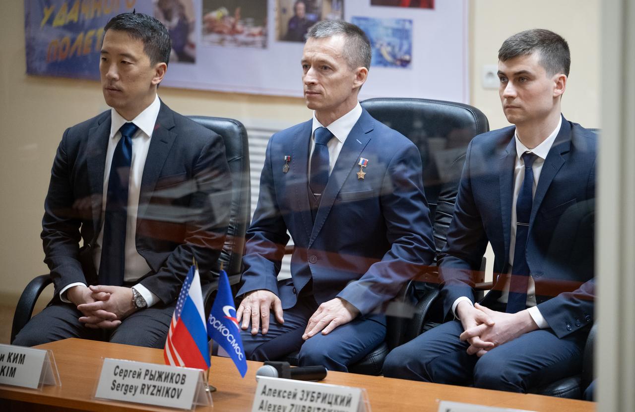 Expedition 73 crewmembers NASA astronaut Jonny Kim, left, and Roscosmos cosmonauts Sergey Ryzhikov and Alexey Zubritskiy seen during the State Commission meeting to approve the Soyuz launch of Expedition 73 to the International Space Station, Monday, April 7, 2025, at the Cosmonaut Hotel in Baikonur, Kazakhstan. Kim, Ryzhikov, Zubritskiy, are scheduled to launch aboard their Soyuz MS-27 spacecraft on April 8. Photo Credit: (NASA/Joel Kowsky)