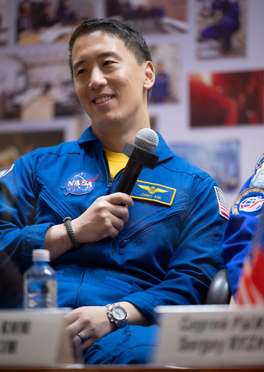 NASA astronaut Jonny Kim is seen in quarantine, behind glass, during a press conference, Monday, April 7, 2025 a the Cosmonaut Hotel in Baikonur, Kazakhstan. Expedition 73 crew members: NASA astronaut Jonny Kim, and Roscosmos cosmonauts Sergey Ryzhikov and Alexey Zubritskiy, are scheduled to launch aboard their Soyuz MS-27 spacecraft on April 8. Photo Credit: (NASA/Joel Kowsky)