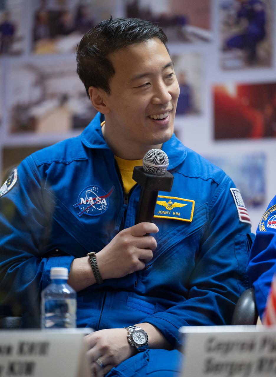NASA astronaut Jonny Kim is seen in quarantine, behind glass, during a press conference, Monday, April 7, 2025 a the Cosmonaut Hotel in Baikonur, Kazakhstan. Expedition 73 crew members: NASA astronaut Jonny Kim, and Roscosmos cosmonauts Sergey Ryzhikov and Alexey Zubritskiy, are scheduled to launch aboard their Soyuz MS-27 spacecraft on April 8. Photo Credit: (NASA/Joel Kowsky)