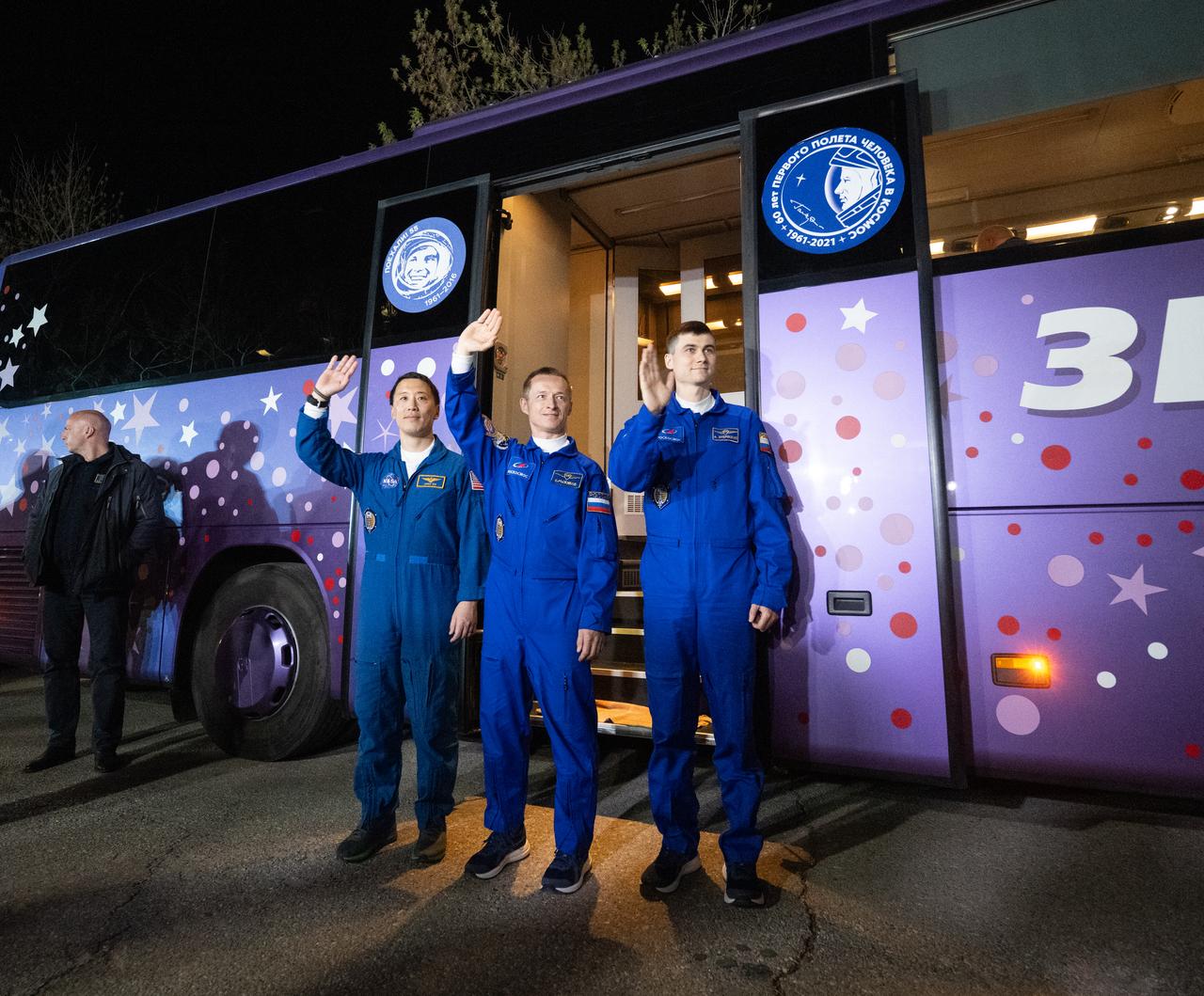 NASA astronaut Jonny Kim, left, and Roscosmos cosmonauts Sergey Ryzhikov and Alexey Zubritskiy, right, wave as they depart the Cosmonaut Hotel to suit-up for their Soyuz launch to the International Space Station, Tuesday, April 8, 2025 (April 7 Eastern Time), in Baikonur, Kazakhstan. The launch will send Kim, Ryzhikov, Zubritskiy on a mission to the International Space Station. Photo Credit: (NASA/Joel Kowsky)