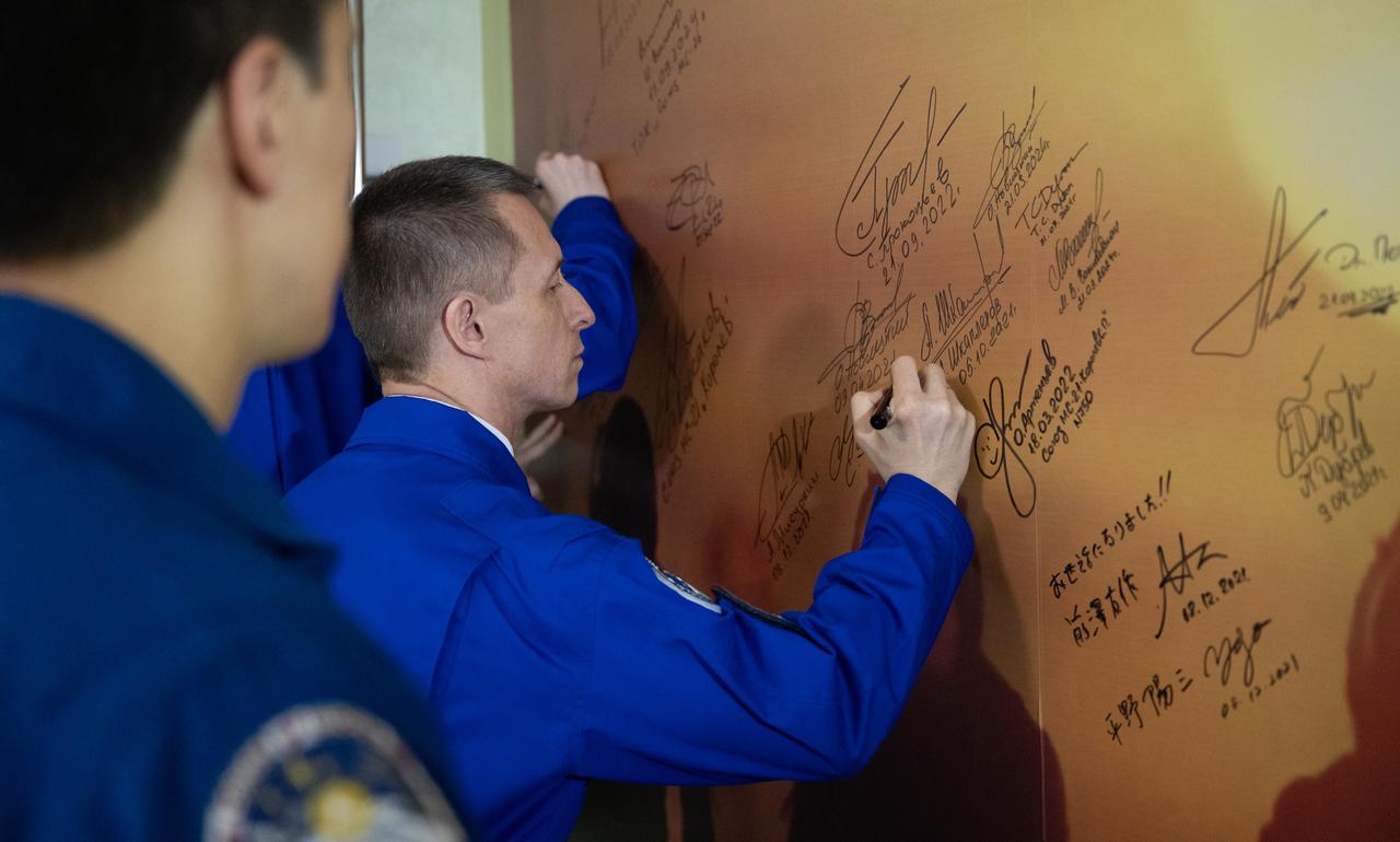 Roscosmos cosmonaut Sergey Ryzhikov signs a mural at the Cosmonaut Hotel prior to departing for suit-up and launch on a Soyuz rocket with fellow crewmates NASA astronaut Jonny Kim and Roscosmos cosmonaut Alexey Zubritskiy, Tuesday, April 8, 2025 (April 7 Eastern Time), in Baikonur, Kazakhstan. The launch will send Kim, Ryzhikov, Zubritskiy, on a mission to the International Space Station. Photo Credit: (NASA/Joel Kowsky)