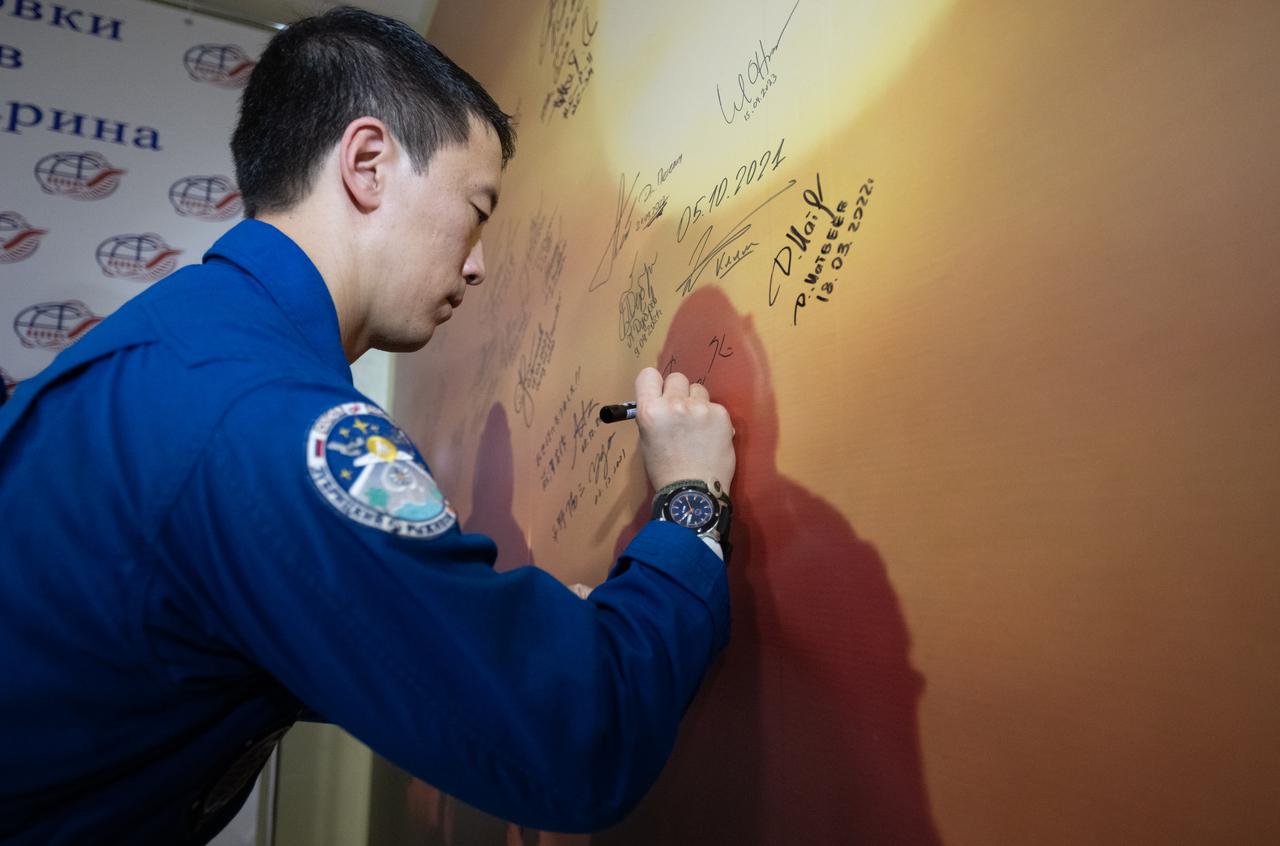 NASA astronaut Jonny Kim signs a mural at the Cosmonaut Hotel prior to departing for suit-up and launch on a Soyuz rocket with fellow crewmates Roscosmos cosmonauts Sergey Ryzhikov and Alexey Zubritskiy, Tuesday, April 8, 2025 (April 7 Eastern Time), in Baikonur, Kazakhstan. The launch will send Kim, Ryzhikov, Zubritskiy, on a mission to the International Space Station. Photo Credit: (NASA/Joel Kowsky)