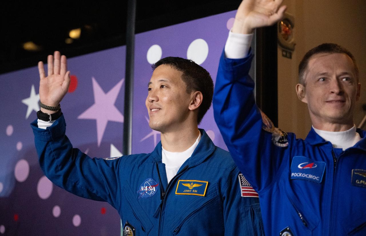 NASA astronaut Jonny Kim waves as he prepares to depart the Cosmonaut Hotel with fellow crewmates Roscosmos cosmonauts Sergey Ryzhikov and Alexey Zubritskiy to suit-up for their Soyuz launch to the International Space Station, Tuesday, April 8, 2025 (April 7 Eastern Time), in Baikonur, Kazakhstan. The launch will send Kim, Ryzhikov, Zubritskiy on a mission to the International Space Station. Photo Credit: (NASA/Joel Kowsky)