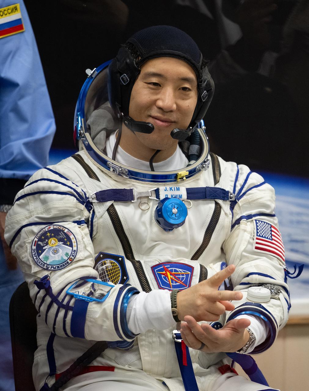 NASA astronaut Jonny Kim plays rock, paper, scissors with his children as he waits to have his Russian Sokol suit pressure checked as he and fellow crewmates, Roscosmos cosmonauts Sergey Ryzhikov and Alexey Zubritskiy prepare for their Soyuz launch to the International Space Station Tuesday, April 8, 2025 (April 7 Eastern Time) in Baikonur, Kazakhstan. The launch will send Kim, Ryzhikov, Zubritskiy on a mission to the International Space Station. Photo Credit: (NASA/Joel Kowsky)