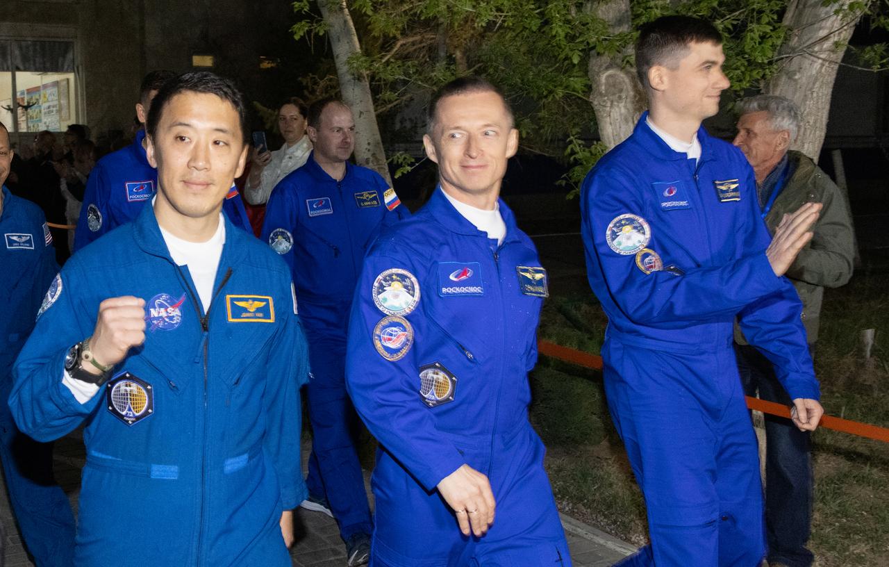 NASA astronaut Jonny Kim, left, and Roscosmos cosmonauts Sergey Ryzhikov, center, and Alexey Zubritskiy, right, are seen as they walk out of the Cosmonaut Hotel as they prepare to head to suit-up for their Soyuz launch to the International Space Station, Tuesday, April 8, 2025, in Baikonur, Kazakhstan. The launch will send Kim, Ryzhikov, Zubritskiy on a mission to the International Space Station. Photo Credit: (NASA/Victor Zelentsov)