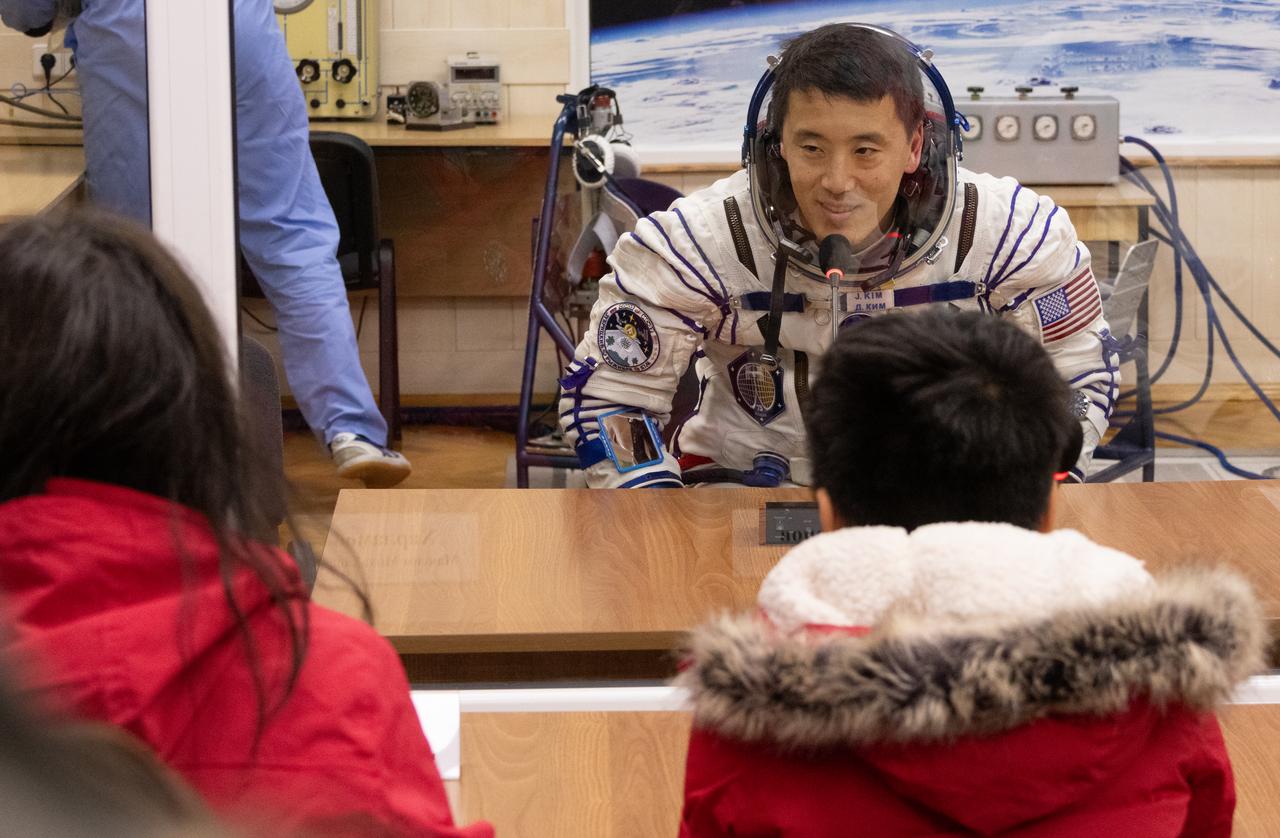 NASA astronaut Jonny Kim talks to family and friends as he and fellow Expedition 73 crewmates Roscosmos cosmonauts Sergey Ryzhikov and Alexey Zubritskiy prepare for their Soyuz launch to the International Space Station Tuesday, April 8, 2025 in Baikonur, Kazakhstan. The launch will send Kim, Ryzhikov, Zubritskiy on a mission to the International Space Station. Photo Credit: (NASA/Victor Zelentsov)
