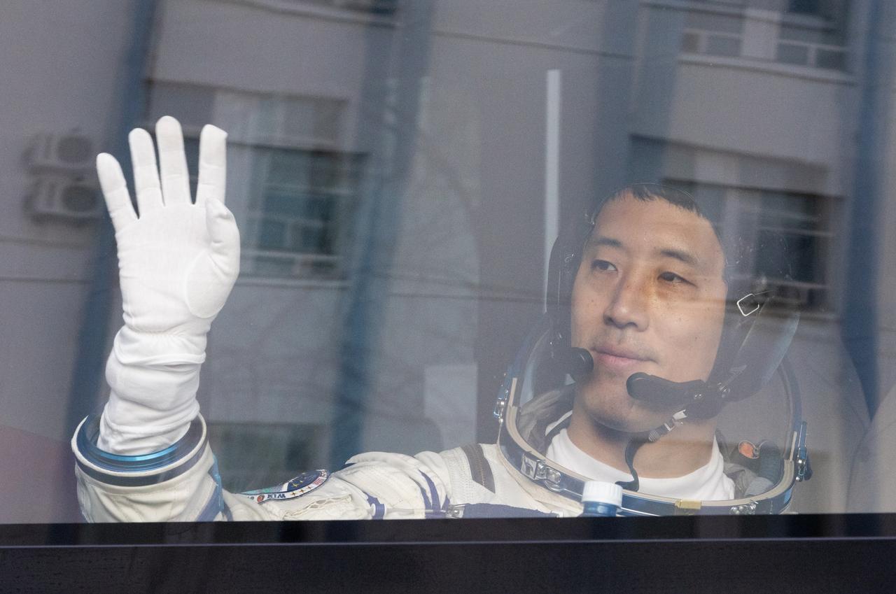NASA astronaut Jonny Kim waves as he and fellow Expedition 73 crewmates Roscosmos cosmonauts Sergey Ryzhikov and Alexey Zubritskiy depart building 254 for their Soyuz launch to the International Space Station Tuesday, April 8, 2025 in Baikonur, Kazakhstan. The launch will send Kim, Ryzhikov, Zubritskiy on a mission to the International Space Station. Photo Credit: (NASA/Victor Zelentsov)