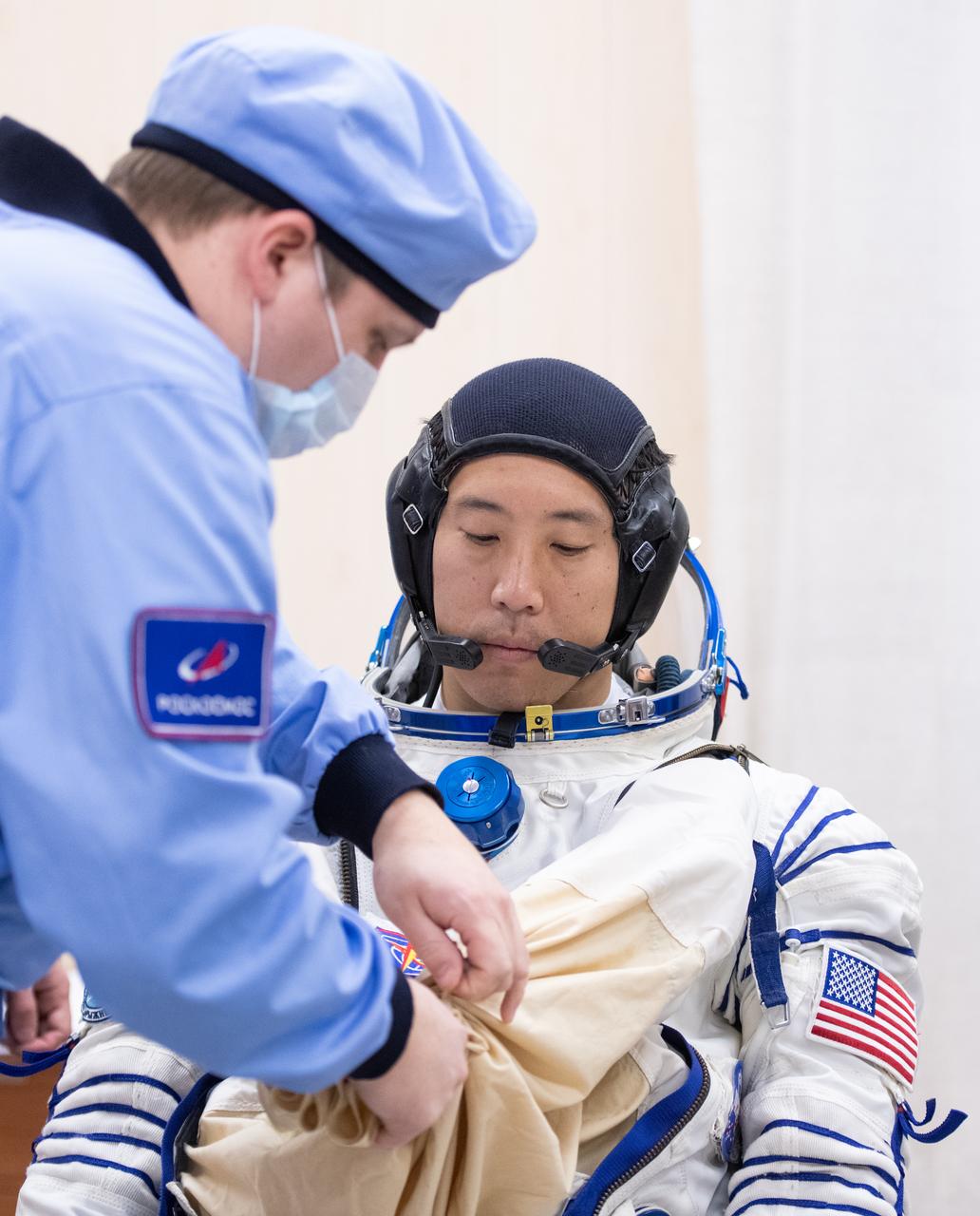NASA astronaut Jonny Kim is helped into his Russian Sokol suit as he and fellow crewmates, Roscosmos cosmonauts Sergey Ryzhikov and Alexey Zubritskiy prepare for their Soyuz launch to the International Space Station Tuesday, April 8, 2025 (April 7 Eastern Time), in Baikonur, Kazakhstan. The launch will send Kim, Ryzhikov, Zubritskiy on a mission to the International Space Station. Photo Credit: (NASA/GCTC/Pavel Shvets)