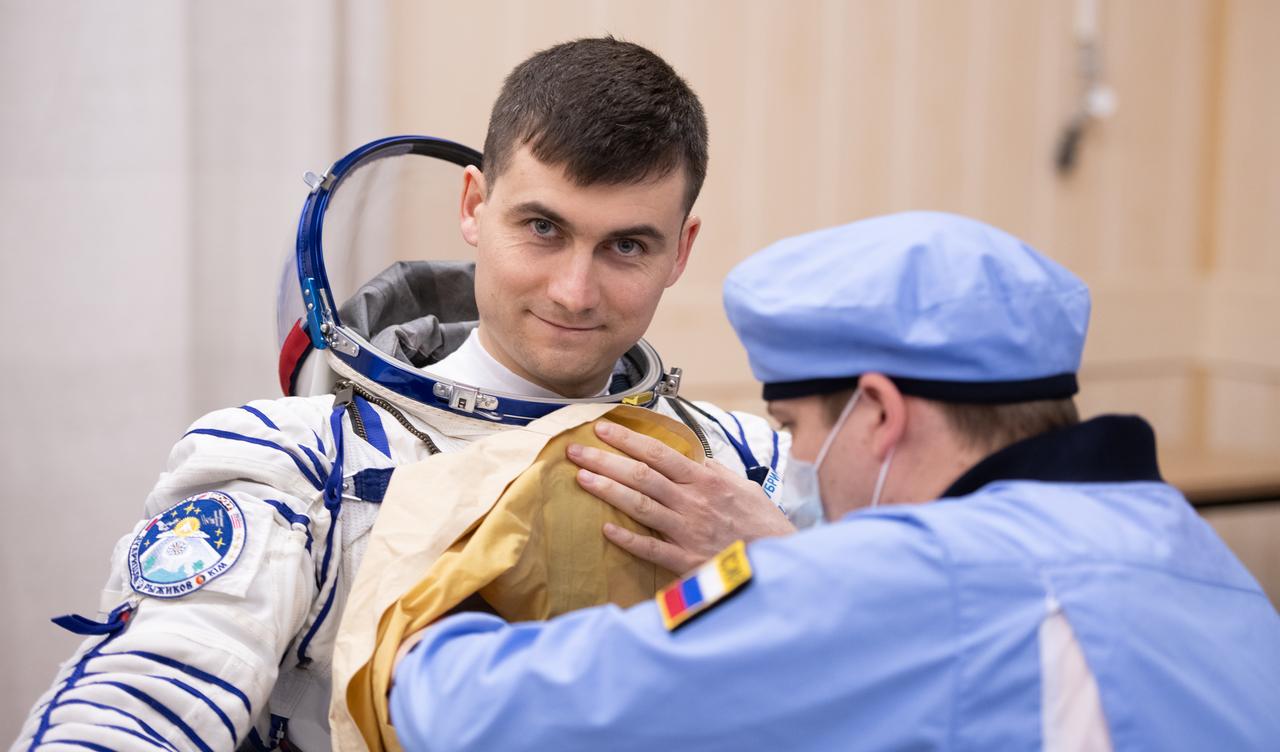 Roscosmos cosmonaut Alexey Zubritskiy is helped into his Russian Sokol suit as he and fellow crewmates, NASA astronaut Jonny Kim and \Sergey Ryzhikov prepare for their Soyuz launch to the International Space Station Tuesday, April 8, 2025 (April 7 Eastern Time), in Baikonur, Kazakhstan. The launch will send Kim, Ryzhikov, Zubritskiy on a mission to the International Space Station. Photo Credit: (NASA/GCTC/Pavel Shvets)