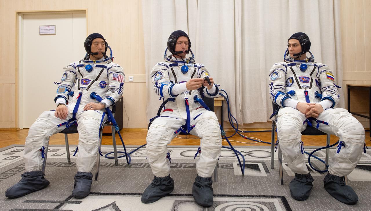 NASA astronaut Jonny Kim, left, and Roscosmos cosmonauts Sergey Ryzhikov, center, and Alexey Zubritskiy, right, are seen after donning their Russian Sokol suits as they prepare for their Soyuz launch to the International Space Station Tuesday, April 8, 2025 (April 7 Eastern Time), in Baikonur, Kazakhstan. The launch will send Kim, Ryzhikov, Zubritskiy on a mission to the International Space Station. Photo Credit: (NASA/GCTC/Pavel Shvets)