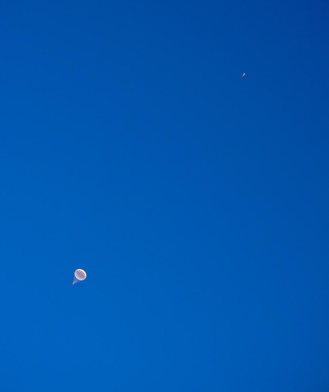 The Soyuz MS-26 spacecraft, lower left, and it’s drogue parachute, are seen as the spacecraft lands in a remote area near the town of Zhezkazgan, Kazakhstan with Expedition 72 NASA astronaut Don Pettit, and Roscosmos cosmonauts Alexey Ovchinin and Ivan Vagner aboard, Sunday, April 20, 2025, (April 19 Eastern). The trio are returning to Earth after logging 220 days in space as members of Expeditions 71 and 72 aboard the International Space Station. Photo Credit: (NASA/Bill Ingalls)