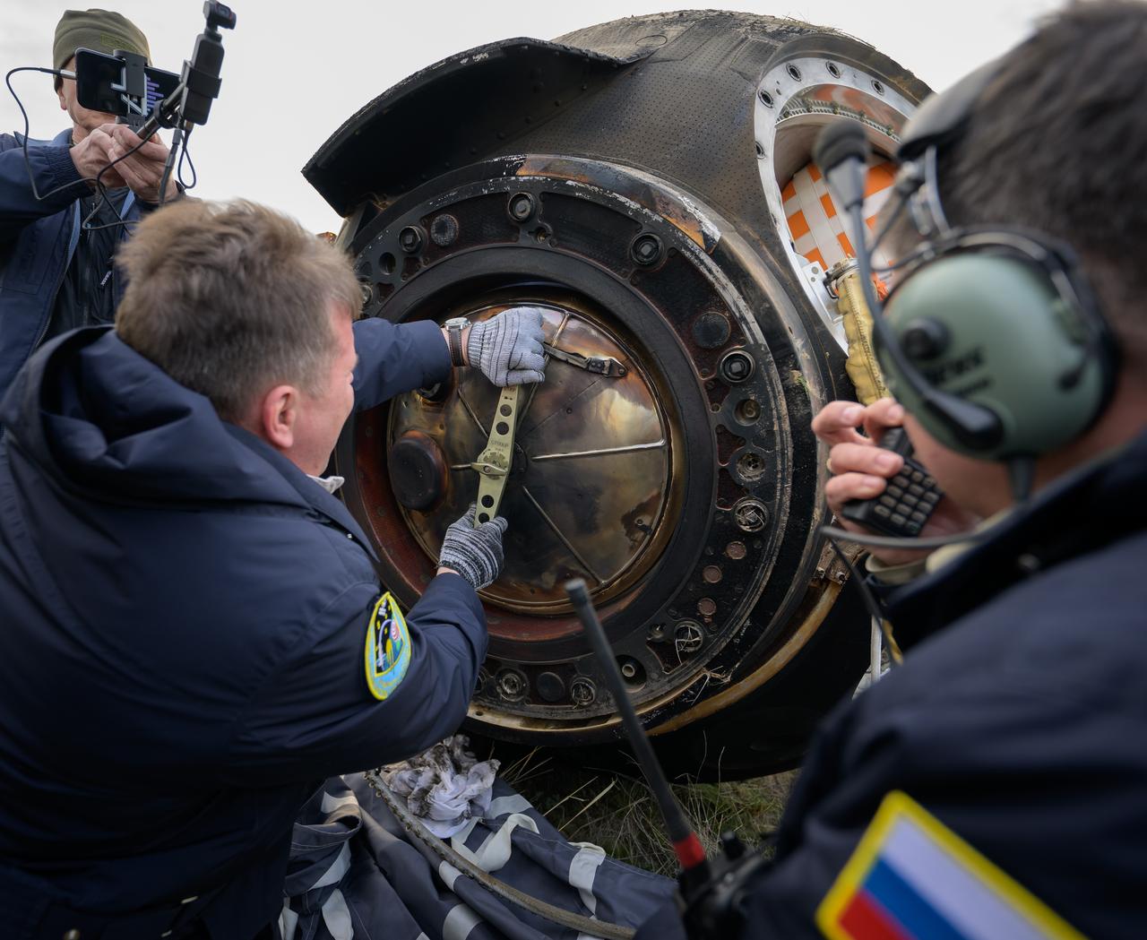 Russian Search and Rescue teams arrive at the Soyuz MS-26 spacecraft shortly after it landed in a remote area near the town of Zhezkazgan, Kazakhstan with Expedition 72 NASA astronaut Don Pettit, and Roscosmos cosmonauts Alexey Ovchinin and Ivan Vagner aboard, Sunday, April 20, 2025, (April 19 Eastern). The trio returned to Earth after logging 220 days in space as members of Expeditions 71 and 72 aboard the International Space Station. Photo Credit: (NASA/Bill Ingalls)