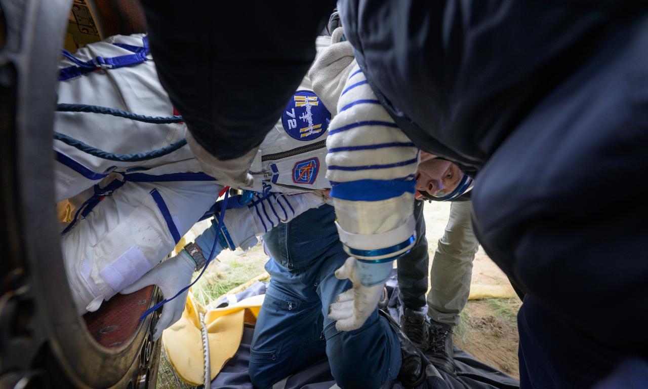 Roscosmos cosmonaut Ivan Vagner is helped out of the Soyuz MS-26 spacecraft just minutes after he, Roscosmos cosmonaut Alexey Ovchinin, and NASA astronaut Don Pettit, landed in a remote area near the town of Zhezkazgan, Kazakhstan on Sunday, April 20, 2025, (April 19 Eastern). The trio returned to Earth after logging 220 days in space as members of Expeditions 71 and 72 aboard the International Space Station. Photo Credit: (NASA/Bill Ingalls)