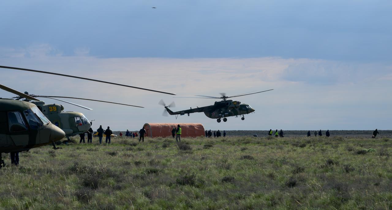 Russian support personnel work around the Soyuz MS-26 spacecraft shortly after it landed in a remote area near the town of Zhezkazgan, Kazakhstan with Expedition 72 NASA astronaut Don Pettit, and Roscosmos cosmonauts Alexey Ovchinin and Ivan Vagner aboard, Sunday, April 20, 2025, (April 19 Eastern). The trio returned to Earth after logging 220 days in space as members of Expeditions 71 and 72 aboard the International Space Station. Photo Credit: (NASA/Bill Ingalls)