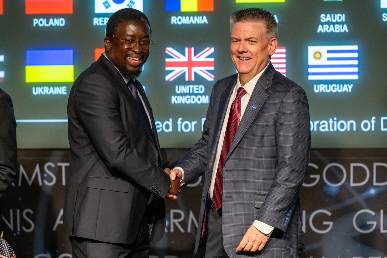 Director General of the Senegalese space agency (ASES) Maram Kairé, left, and NASA Chief of Staff Brian Hughes, right, shake hands during an Artemis Accords signing ceremony Thursday, July 24, 2025, at the Mary W. Jackson NASA Headquarters building in Washington. Senegal is the 56th country to sign the Artemis Accords, which establish a practical set of principles to guide space exploration cooperation among nations participating in NASA’s Artemis program. Photo Credit: (NASA/Keegan Barber)