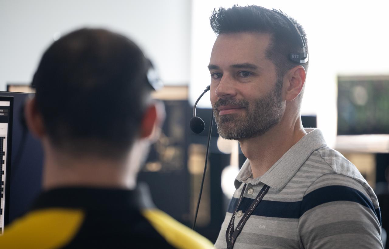 John Posey, lead engineer for Dragon in NASA's Commercial Crew Program, talks with Max Schneiderman, an aerospace flight systems engineer at NASA, as they monitor the countdown during a dress rehearsal in preparation for the launch of a SpaceX Falcon 9 rocket carrying the company's Dragon spacecraft on NASA’s SpaceX Crew-11 mission with NASA astronauts Zena Cardman, Mike Fincke, JAXA (Japan Aerospace Exploration Agency) astronaut Kimiya Yui, and Roscosmos cosmonaut Oleg Platonov onboard, Monday, July 28, 2025, in the control room of SpaceX’s HangerX at NASA’s Kennedy Space Center in Florida. NASA’s SpaceX Crew-11 mission is the eleventh crew rotation mission of the SpaceX Dragon spacecraft and Falcon 9 rocket to the International Space Station as part of the agency’s Commercial Crew Program. Cardman, Fincke, Yui, Platonov are scheduled to launch on 12:09 p.m. EDT on Thursday, July 31, from Launch Complex 39A at the NASA's Kennedy Space Center. Photo Credit: (NASA/Joel Kowsky)
