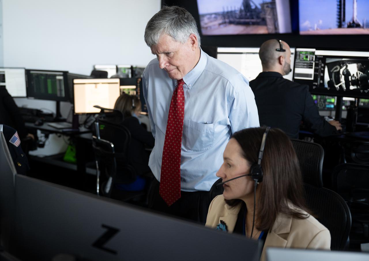 Steve Stich, manager of NASA’s Commercial Crew Program, left, speaks with Nicole Jordan, NASA operations manager for the Commercial Crew Program, as teams monitor the countdown of a launch attempt of a SpaceX Falcon 9 rocket carrying the company's Dragon spacecraft on NASA’s SpaceX Crew-11 mission with NASA astronauts Zena Cardman, Mike Fincke, JAXA (Japan Aerospace Exploration Agency) astronaut Kimiya Yui, and Roscosmos cosmonaut Oleg Platonov onboard, Thursday, July 31, 2025, in the control center of SpaceX’s HangarX at NASA’s Kennedy Space Center in Florida. NASA’s SpaceX Crew-11 mission is the eleventh crew rotation mission of the SpaceX Dragon spacecraft and Falcon 9 rocket to the International Space Station as part of the agency’s Commercial Crew Program. Today’s launch of Cardman, Fincke, Yui, Platonov was scrubbed due to weather and is now scheduled for 11:43 a.m. EDT on Friday, August 1, from Launch Complex 39A at the NASA's Kennedy Space Center. Photo Credit: (NASA/Joel Kowsky)