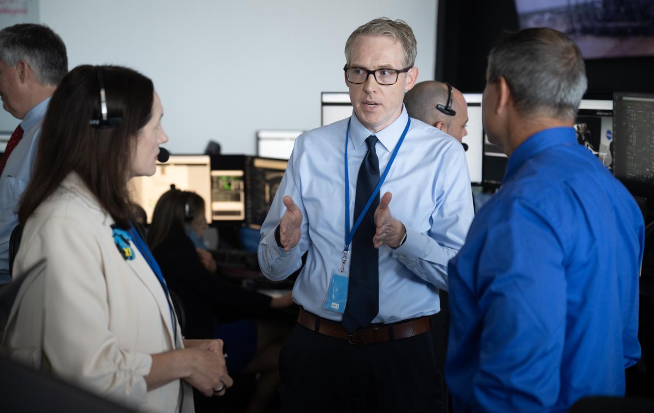 Jeremy Hart, Integrated Performance Chief Engineer for NASA's Commercial Crew Program, center, speaks with Nicole Jordan, NASA operations manager for the Commercial Crew Program, left, and Kevin Vega, Commercial Crew Program Chief Engineer, as teams monitor the countdown of a launch attempt of a SpaceX Falcon 9 rocket carrying the company's Dragon spacecraft on NASA’s SpaceX Crew-11 mission with NASA astronauts Zena Cardman, Mike Fincke, JAXA (Japan Aerospace Exploration Agency) astronaut Kimiya Yui, and Roscosmos cosmonaut Oleg Platonov onboard, Thursday, July 31, 2025, in the control center of SpaceX’s HangarX at NASA’s Kennedy Space Center in Florida. NASA’s SpaceX Crew-11 mission is the eleventh crew rotation mission of the SpaceX Dragon spacecraft and Falcon 9 rocket to the International Space Station as part of the agency’s Commercial Crew Program. Today’s launch of Cardman, Fincke, Yui, Platonov was scrubbed due to weather and is now scheduled for 11:43 a.m. EDT on Friday, August 1, from Launch Complex 39A at the NASA's Kennedy Space Center. Photo Credit: (NASA/Joel Kowsky)