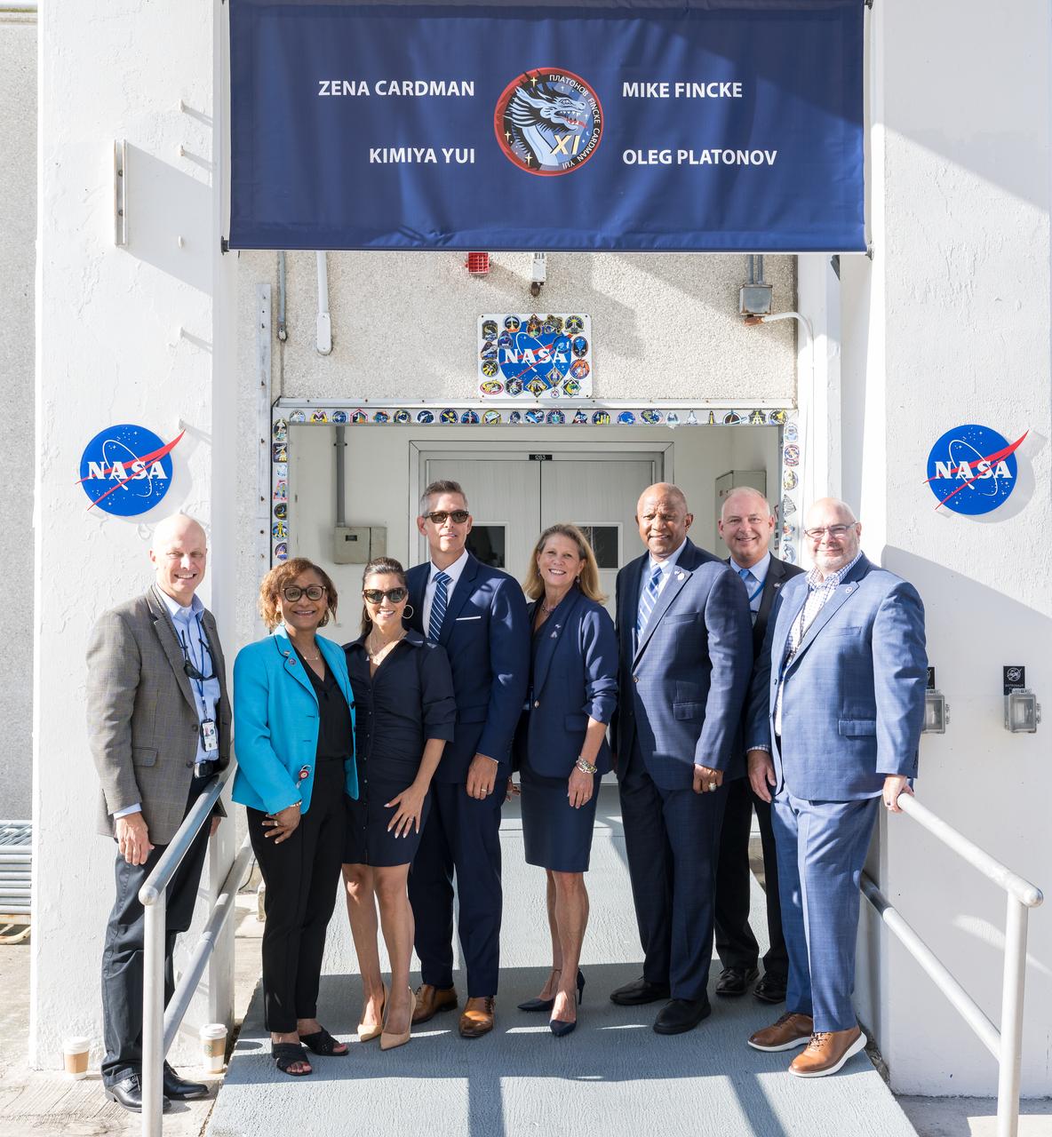 From left to right, Acting Director of NASA's Johnson Space Center, Steve Koerner, Acting NASA Associate Administrator, Vanessa Wyche, wife of Acting NASA Administrator Sean Duffy, Rachel Campos-Duffy, Sean Duffy, Acting Associate Administrator, Exploration Systems Development, Lori Glaze, Acting Director of NASA's John F. Kennedy Space Center, Kelvin Manning, Acting Deputy Director of NASA's Johnson Space Center, Norm Knight, and director of NASA's Marshall Space Flight Center, Joseph Pelfrey pose for a photo at the door to the Neil A. Armstrong Operations and Checkout Building after NASA astronauts Zena Cardman, Mike Fincke, JAXA (Japan Aerospace Exploration Agency) astronaut Kimiya Yui, and Roscosmos cosmonaut Oleg Platonov, departed for Launch Complex 39A to board the SpaceX Dragon spacecraft for the Crew-11 mission launch, before it was scrubbed due to weather concerns, Thursday, July 31, 2025, at NASA’s Kennedy Space Center in Florida. NASA’s SpaceX Crew-11 mission is the eleventh crew rotation mission of the SpaceX Crew Dragon spacecraft and Falcon 9 rocket to the International Space Station as part of the agency’s Commercial Crew Program. Cardman, Fincke, Yui, and Platonov launched at 11:43 a.m. EDT, Friday, August 1, from Launch Complex 39A at the NASA's Kennedy Space Center.  Photo Credit: (NASA/Aubrey Gemignani)