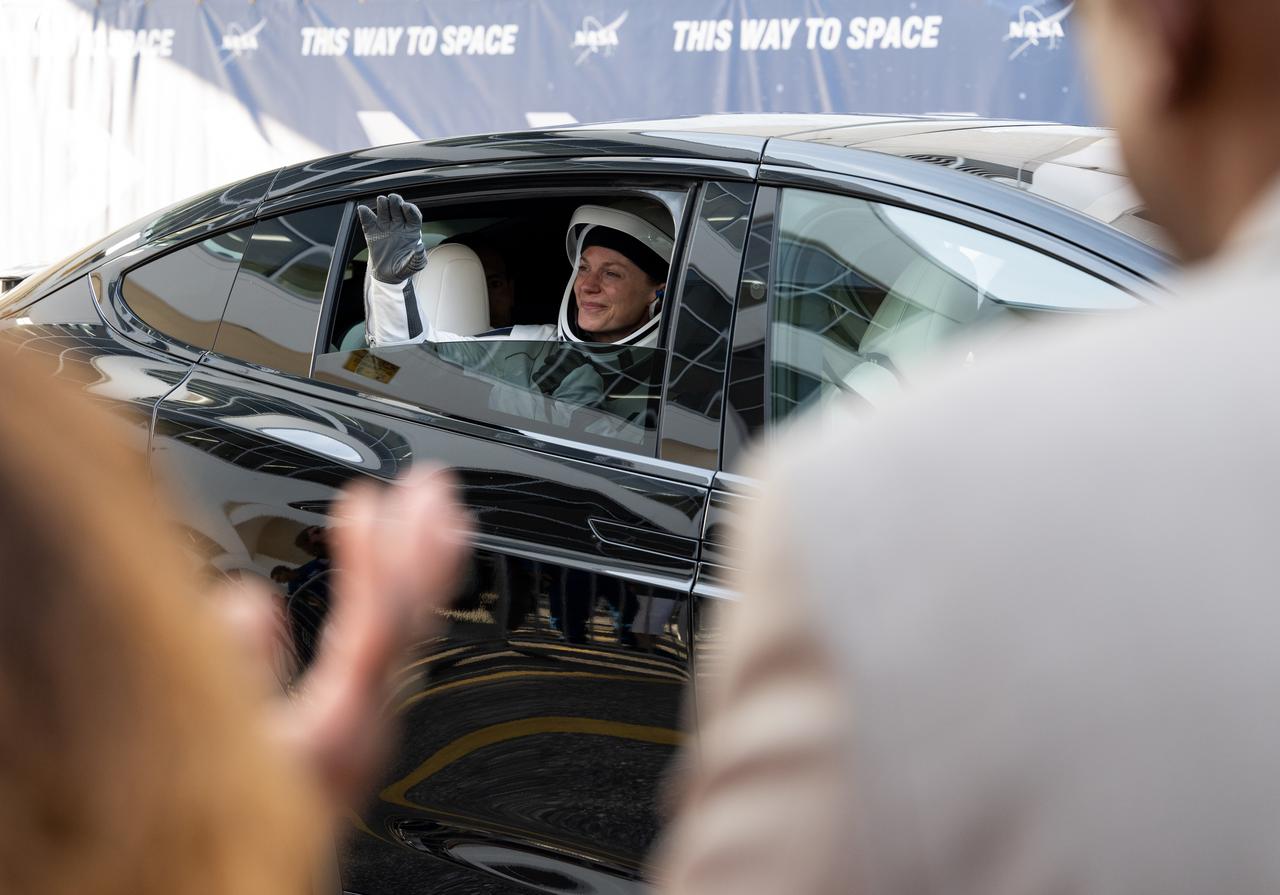 NASA astronauts Zena Cardman waves to friends and family as she and fellow crewmates Mike Fincke, JAXA (Japan Aerospace Exploration Agency) astronaut Kimiya Yui, and Roscosmos cosmonaut Oleg Platonov, depart the Neil  A. Armstrong Operations and Checkout Building for Launch Complex 39A on NASA's Kennedy Space Center to board the SpaceX Dragon spacecraft for the Crew-11 mission launch, Friday, Aug. 1, 2025, at NASA’s Kennedy Space Center in Florida. NASA’s SpaceX Crew-11 mission is the eleventh crew rotation mission of the SpaceX Crew Dragon spacecraft and Falcon 9 rocket to the International Space Station as part of the agency’s Commercial Crew Program. Cardman, Fincke, Yui, Platonov are scheduled to launch at 11:43 a.m. EDT, from Launch Complex 39A at the NASA's Kennedy Space Center.  Photo Credit: (NASA/Joel Kowsky)