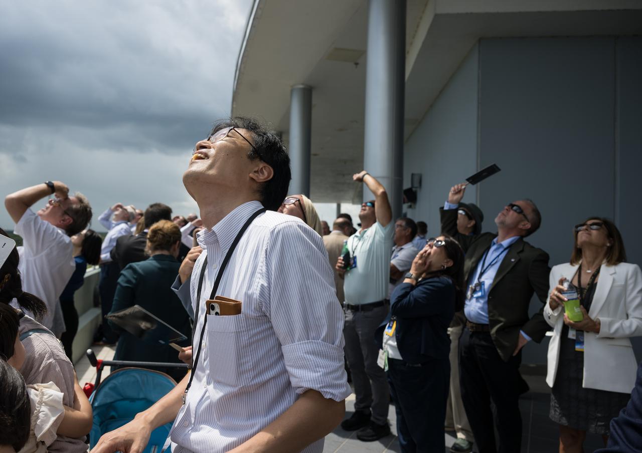A crowd watches as SpaceX Falcon 9 rocket carrying the company's Dragon spacecraft is launched on NASA’s SpaceX Crew-11 mission to the International Space Station with NASA astronauts Zena Cardman, Mike Fincke, JAXA (Japan Aerospace Exploration Agency) astronaut Kimiya Yui, and Roscosmos cosmonaut Oleg Platonov onboard, Friday, Aug. 1, 2025, from NASA's Kennedy Space Center in Florida. NASA’s SpaceX Crew-11 mission is the eleventh crew rotation mission of the SpaceX Dragon spacecraft and Falcon 9 rocket to the International Space Station as part of the agency’s Commercial Crew Program. Cardman, Fincke, Yui, Platonov launched at 12:09 p.m. EDT from Launch Complex 39A at the NASA's Kennedy Space Center to begin a six month mission aboard the orbital outpost. Photo Credit: (NASA/Aubrey Gemignani)