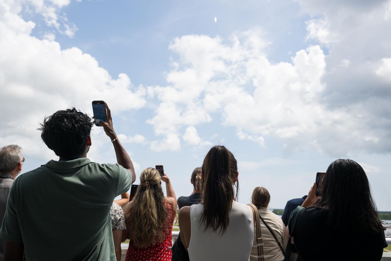 A crowd watches as SpaceX Falcon 9 rocket carrying the company's Dragon spacecraft is launched on NASA’s SpaceX Crew-11 mission to the International Space Station with NASA astronauts Zena Cardman, Mike Fincke, JAXA (Japan Aerospace Exploration Agency) astronaut Kimiya Yui, and Roscosmos cosmonaut Oleg Platonov onboard, Friday, Aug. 1, 2025, from NASA's Kennedy Space Center in Florida. NASA’s SpaceX Crew-11 mission is the eleventh crew rotation mission of the SpaceX Dragon spacecraft and Falcon 9 rocket to the International Space Station as part of the agency’s Commercial Crew Program. Cardman, Fincke, Yui, Platonov launched at 12:09 p.m. EDT from Launch Complex 39A at the NASA's Kennedy Space Center to begin a six month mission aboard the orbital outpost. Photo Credit: (NASA/Aubrey Gemignani)