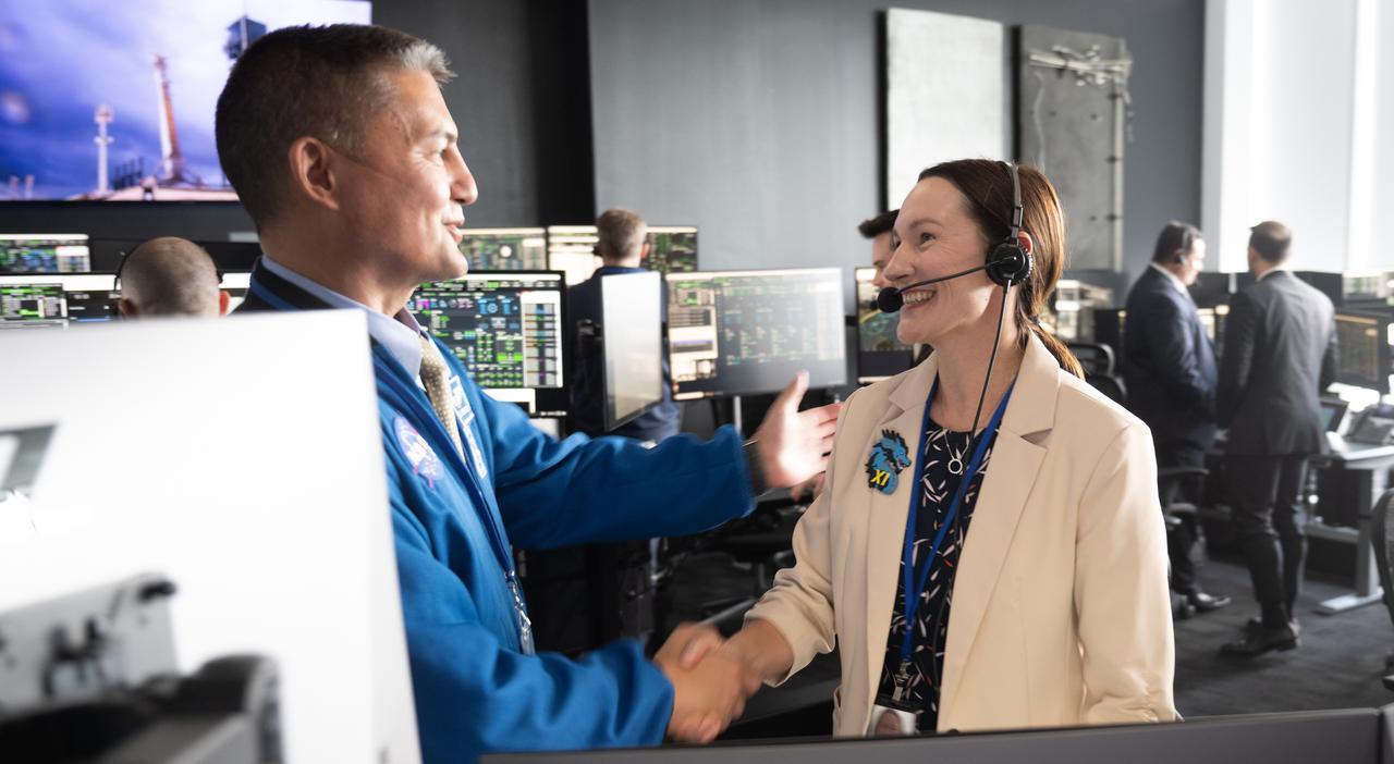 Kjell Lindegren, acting director of flight operations at NASA’s Johnson Space Center, shakes hands with Nicole Jordan, NASA operations manager for the Commercial Crew Program, following the launch of a SpaceX Falcon 9 rocket carrying the company's Dragon spacecraft on the Crew-11 mission with NASA astronauts Zena Cardman, Mike Fincke, JAXA (Japan Aerospace Exploration Agency) astronaut Kimiya Yui, and Roscosmos cosmonaut Oleg Platonov onboard, Friday, Aug. 1, 2025, in the control room of SpaceX’s HangerX at NASA’s Kennedy Space Center in Florida. NASA’s SpaceX Crew-11 mission is the eleventh crew rotation mission of the SpaceX Dragon spacecraft and Falcon 9 rocket to the International Space Station as part of the agency’s Commercial Crew Program. Cardman, Fincke, Yui, Platonov launched at 11:43 a.m. EDT, from Launch Complex 39A at the Kennedy Space Center. Photo Credit: (NASA/Joel Kowsky)